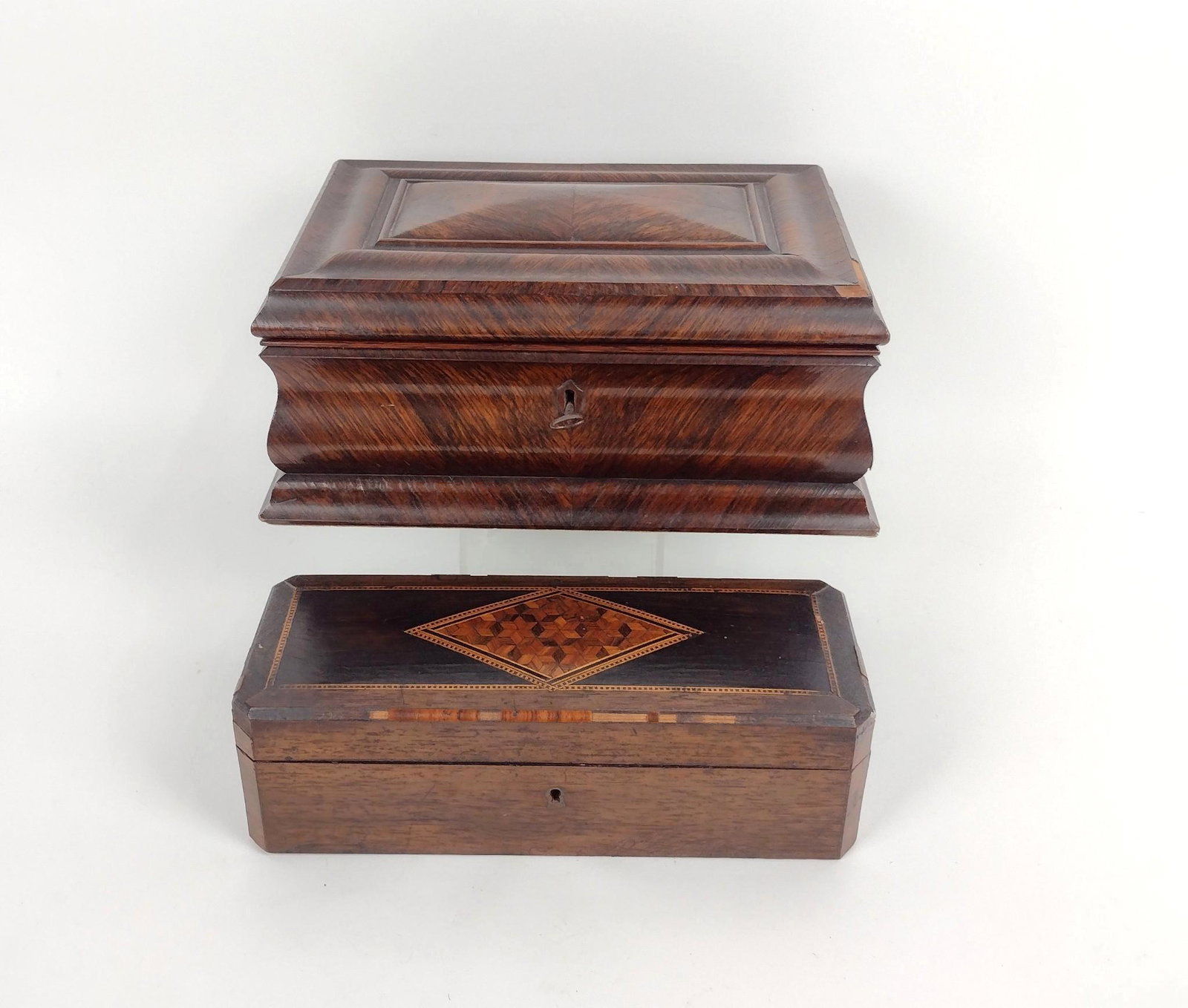 2 Wooden Jewelry Boxes: 11" to 11-3/4" wide X 3-1/2" to 4-3/4" high. Some losses. MEG IMPORTANT: Before bidding, please read the terms and conditions. When you registered for the auction you agreed to these terms and will be