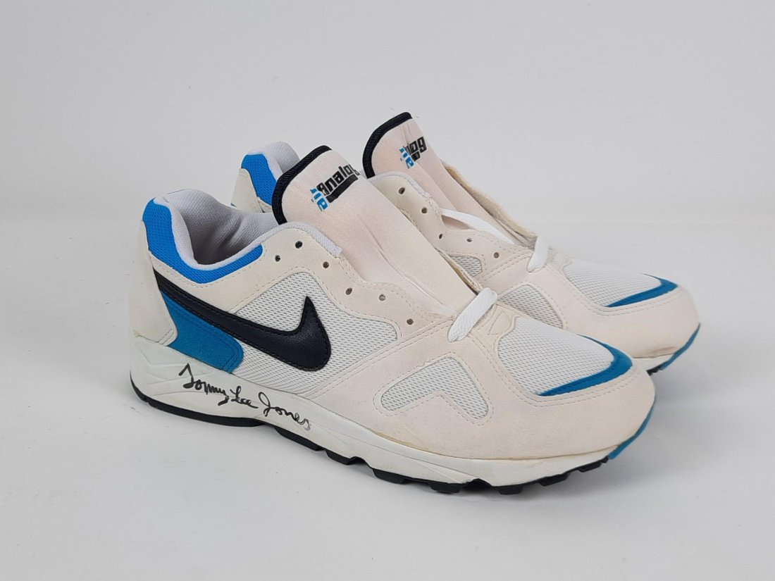 Pr Tommy Lee Jones Autographed Nike Air Analog Sneakers: These sneakers were signed in 1993 during the filming of "The Client". Each sneaker is signed. Size 10.5. Appears to be unworn. Glue where shield means tread is dry and yellowing. LR IMPORTANT: Before