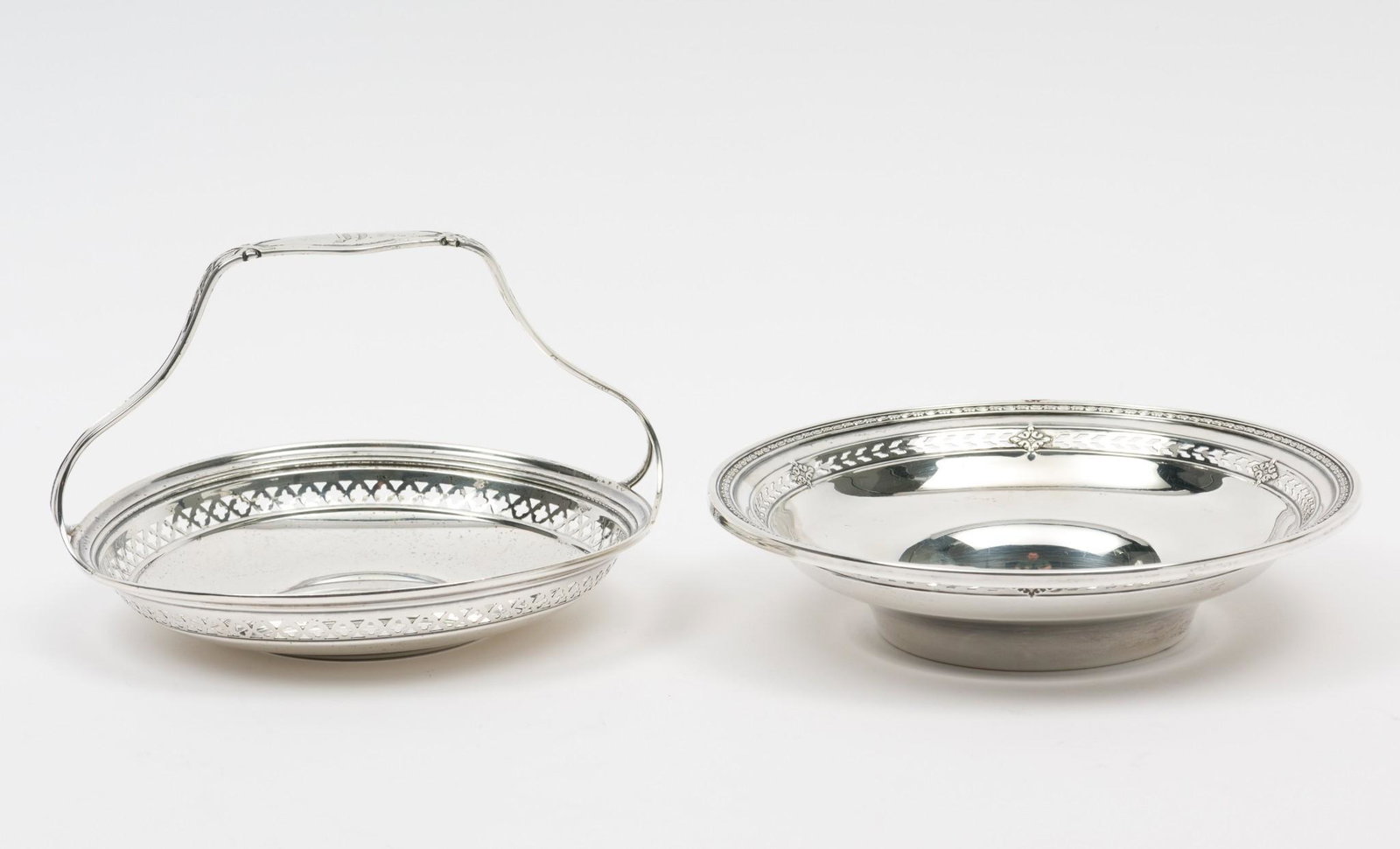 2 Watson Pierced Sterling Bowls: With Watson laurel wreath and sword mark to bottom of each. One bowl with basket handle. Both monogrammed. 4-3/4" diameter to 5-1/2" diameter. 4.3 ozt. Small ding to bowl without handle; see images. R