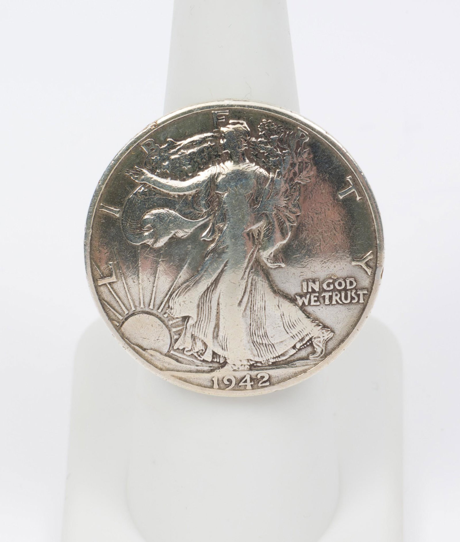 1942 Walking Liberty Sterling Ring: Ring band marked 925. Size 6. 1-1/8" diameter. RM IMPORTANT: Before bidding, please read the terms and conditions. When you registered for the auction you agreed to these terms and will be required to
