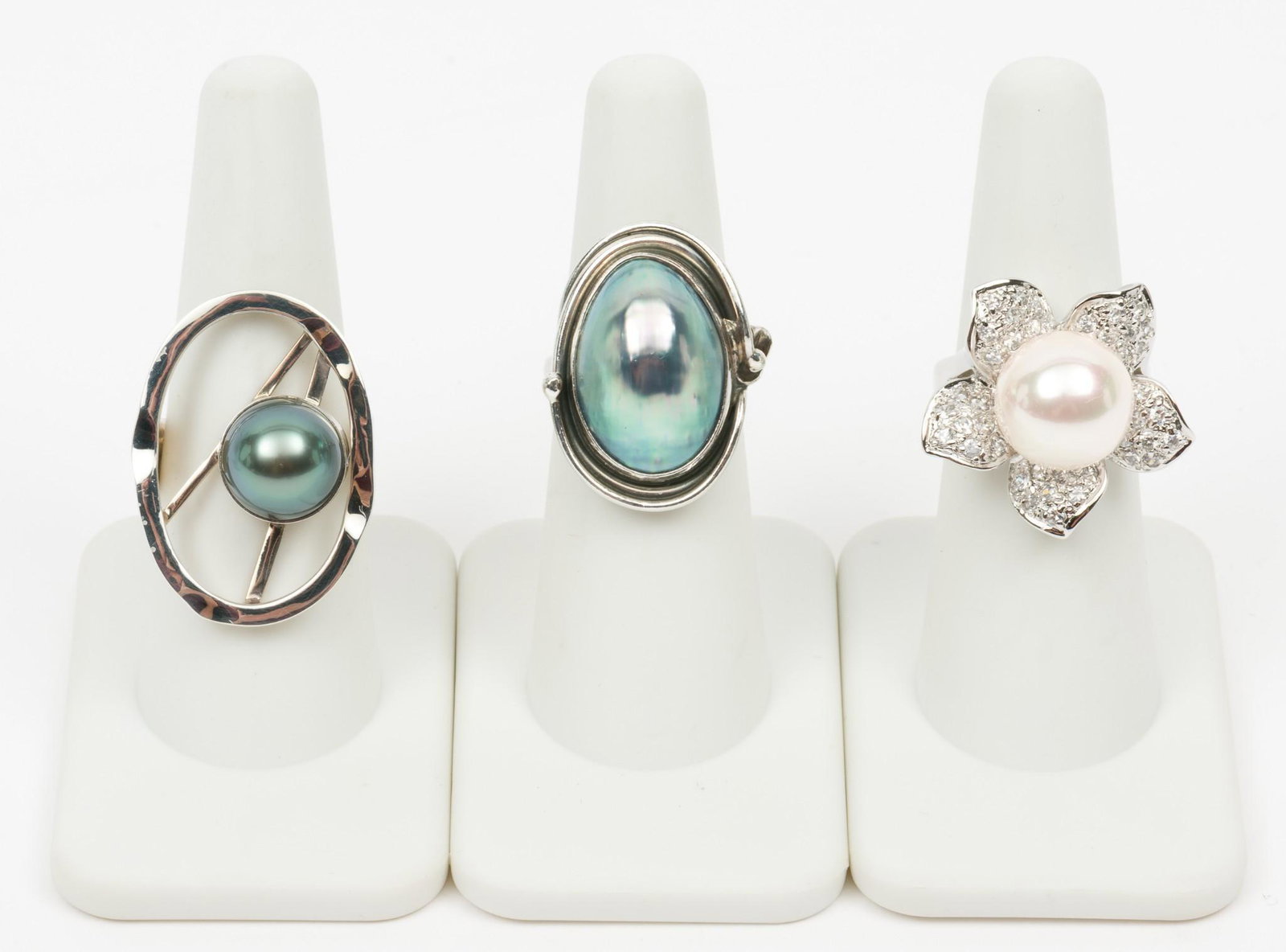 3 Silver, Pearl, and Mother of Pearl Rings: Two marked 925. Floral ring is mother of pearl and CZ. Sizes 5-1/2, 6, and 8. 7/8" to 1-1/8" wide. MH. IMPORTANT: Before bidding, please read the terms and conditions. When you registered for the auct