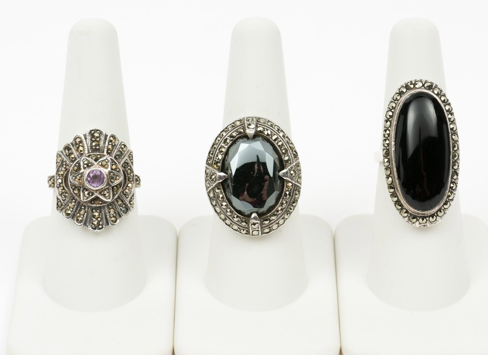 3 Silver Marcasite Rings: With amethyst, onyx, and hematite. Sizes 5-1/2, 7, and 7-1/2. 1" to 1-1/4" wide. MH. IMPORTANT: Before bidding, please read the terms and conditions. When you registered for the auction you agreed to