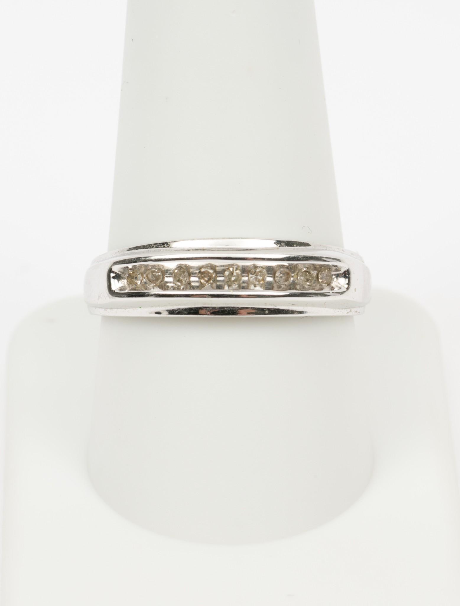 10K White Gold & .18 CTW Diamond Band: Stamped 10k white gold setting with nine .02 carat each single cut round diamonds. Clarity I2, Color I-J. 1.8 dwt. Size 10. EK IMPORTANT: Before bidding, please read the terms and conditions. When you