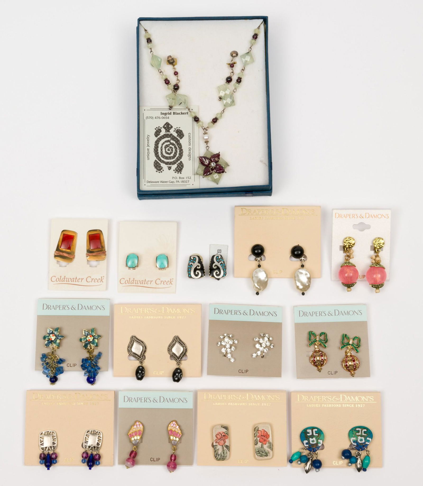 13 Pairs of Earrings and 1 Necklace incl Coldwater Creek: Also includes Draper's & Damon's and Ingrid Blackert Necklace. All unworn on original packaging. Clip-on earrings 1/2" long to 2" long. Necklace 14" long with 2" pendant. MH. IMPORTANT: Before bidding