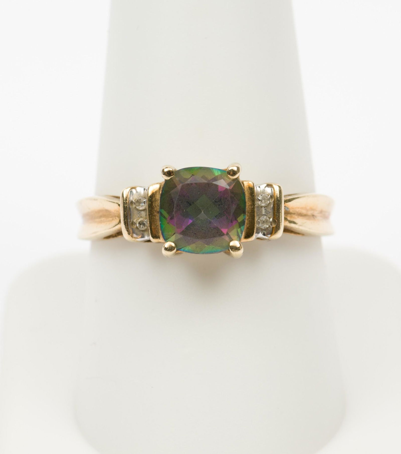 10K Mystic Topaz & Diamond Ring: 10k stamped ring set with cushion cut mystic topaz and four .01 carat each channel set diamonds. 1.7 dwt. Size 9.5. EK IMPORTANT: Before bidding, please read the terms and conditions. When you registe