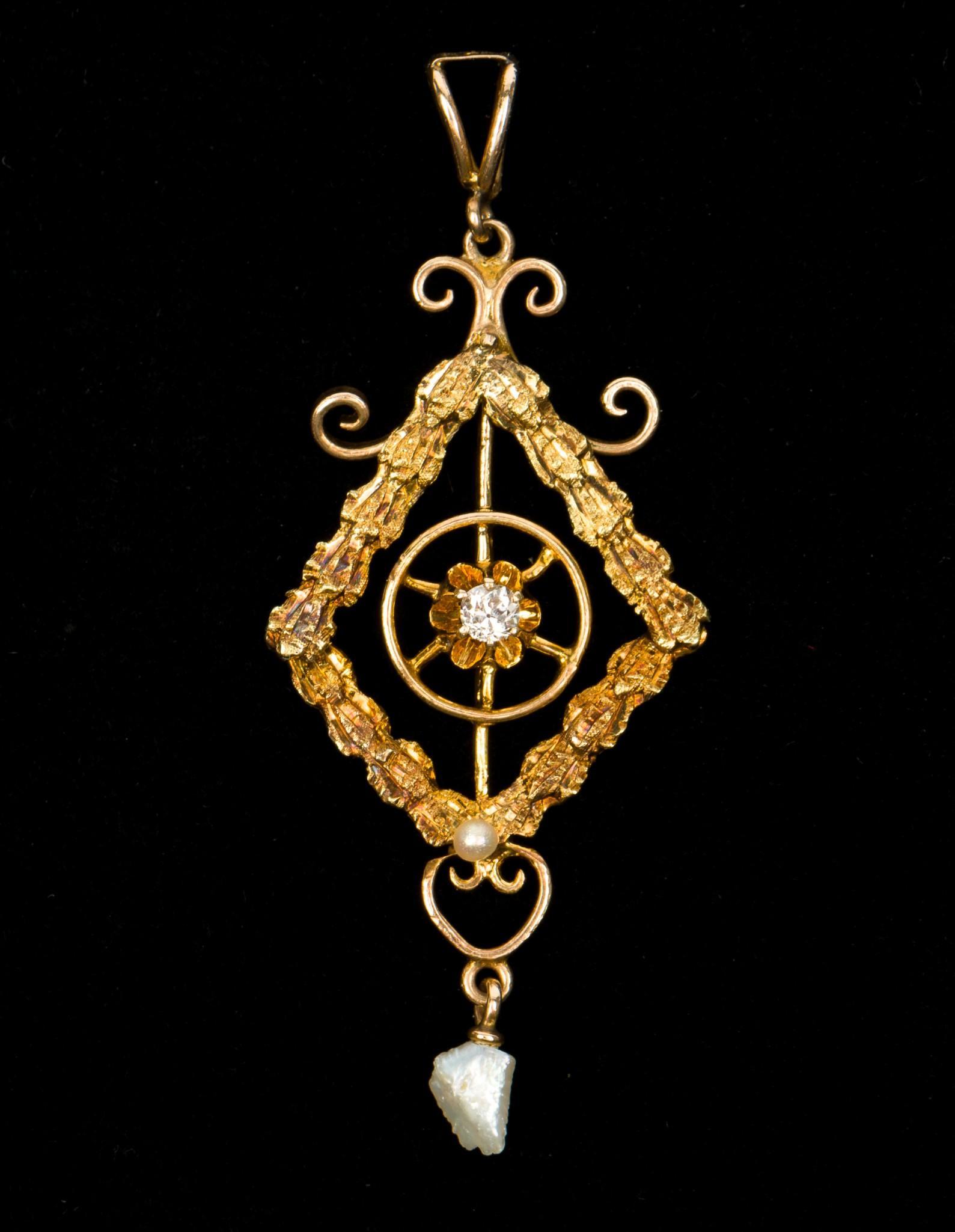 10K Diamond & Pearl Lavaliere: 10k stamped lavaliere set with approximately .05 carat round brilliant cut diamond and seed pearl, with pearl drop. 1 dwt. 3/4" x 1-1/2". EK IMPORTANT: Before bidding, please read the terms and condit