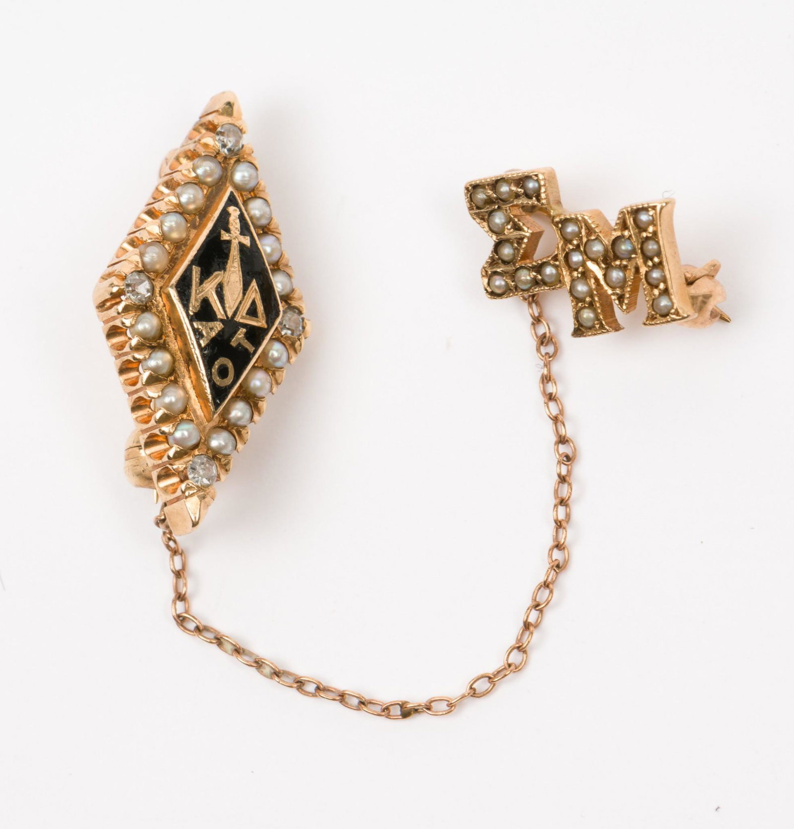14K Kappa Delta Diamond and Seed Pearl Sorority Pin: Tests 14K. With four .01 carat each single cut diamonds and 16 seed pearls. 3/4" long. With Sigma Mu guard. 2.6 dwt. Wear to enamel. MH/EK IMPORTANT: Before bidding, please read the terms and conditio