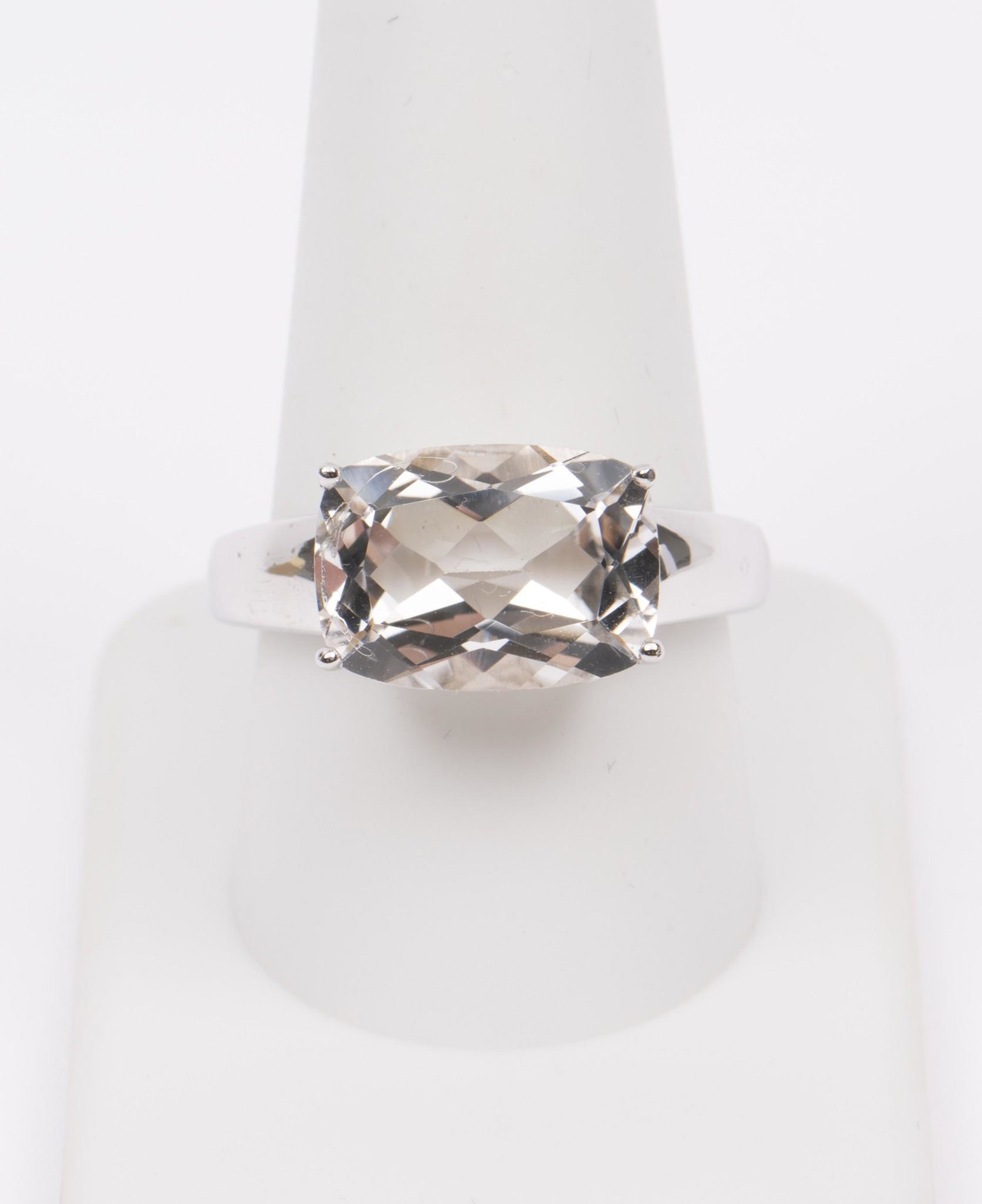 Lenox Sterling Eternal Brilliance Ring: Sterling (stamped 925) ring plated with rhodium, set with oval cushion cut white topaz. Size 10.5. In original Lenox ring box and cardboard gift box. Handwriting to top of box. Includes certificate of