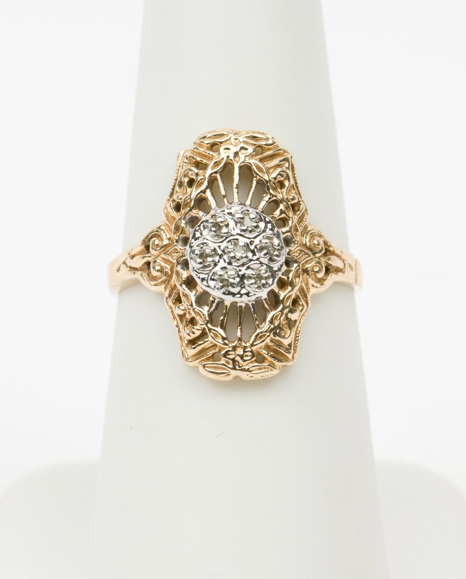 10K White and Yellow Gold and Diamond Ring: Stamped 10k ring set with seven .01 carat each round single cut diamonds. Size 6. 1.5 dwt. MH/EK IMPORTANT: Before bidding, please read the terms and conditions. When you registered for the auction yo