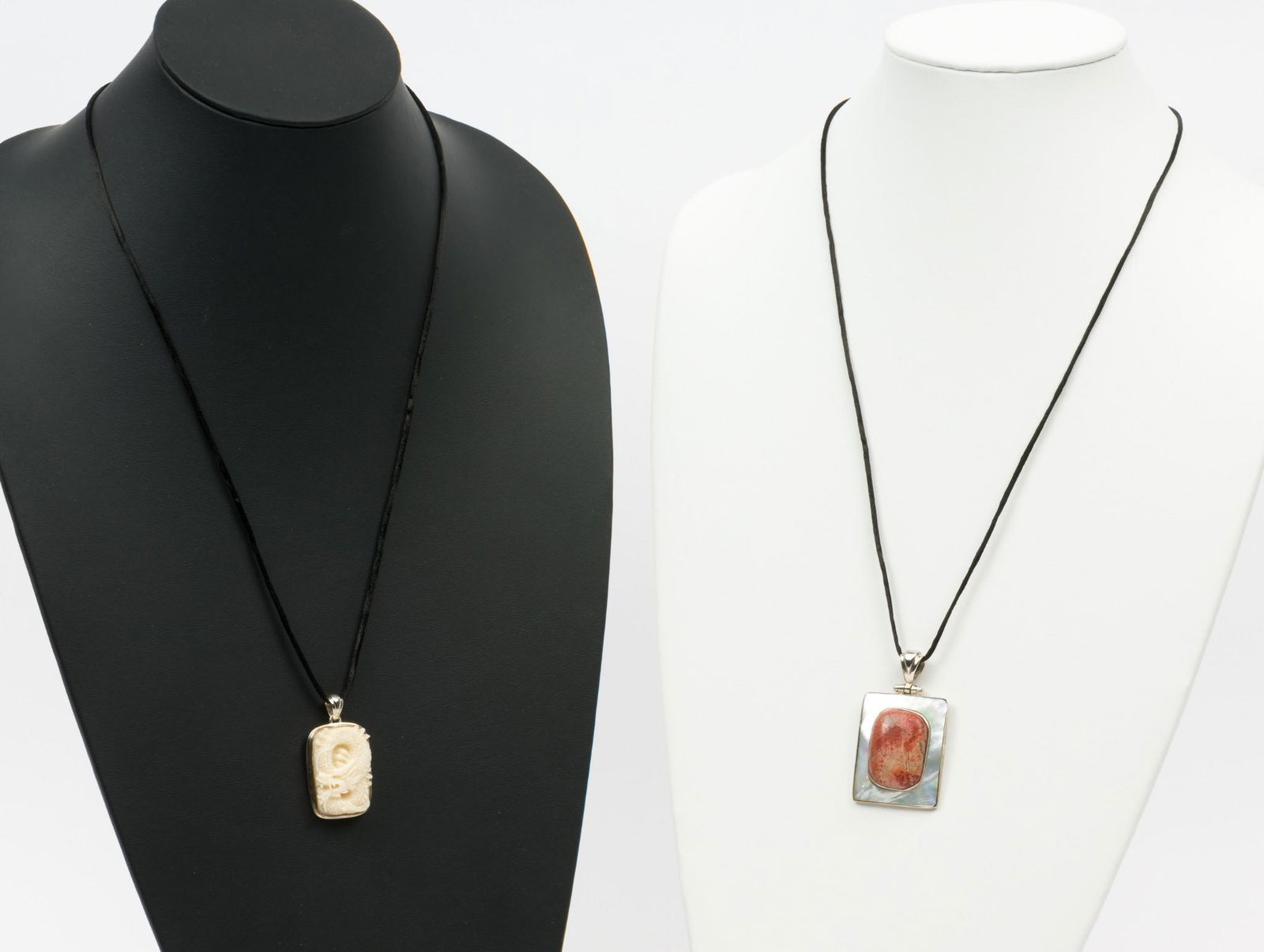 2 Sterling Pendants incl Carved Bone, Jasper: Carved bone dragon pendant 1-1/2" long. Jasper and mother of pearl pendant 2-1/8" long. Both marked 925 and signed BASK. Each on silk display cord. MH. IMPORTANT: Before bidding, please read the terms