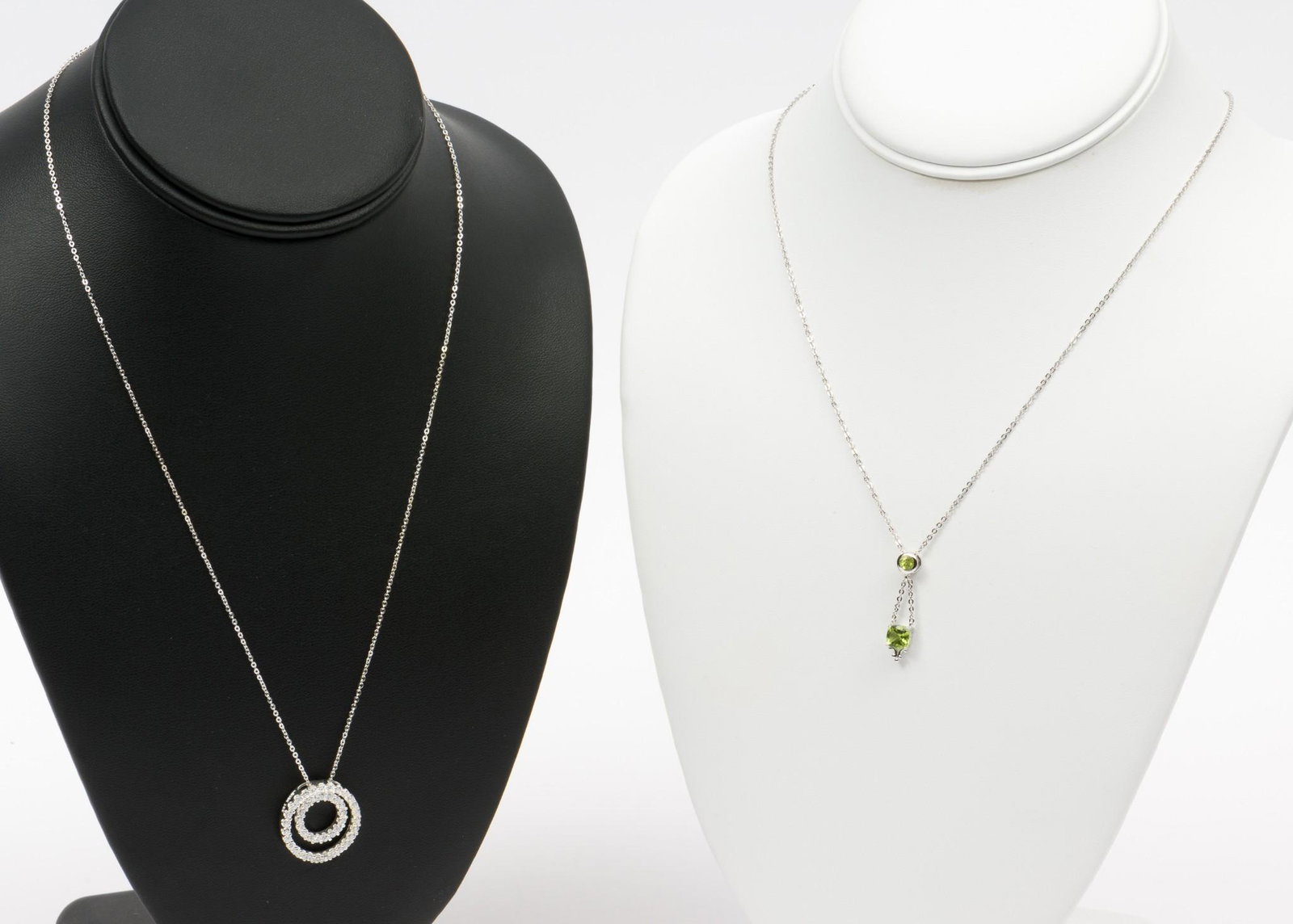 2 Lenox Pendant Necklaces: Elegant impressions necklace; Peridot in sterling setting 1" pendant on 16" sterling chain. Everlasting Circles CZ and sterling pendant 1" long pendant on 20" sterling chain. Each in original box. Han