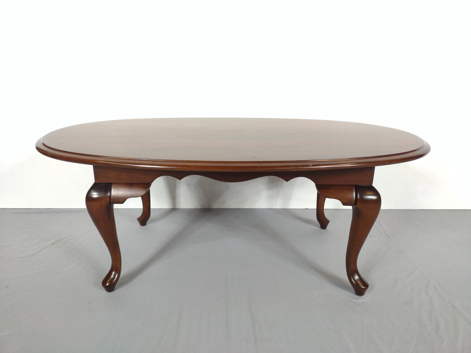 Oval Coffee Table: Made in USA. Refinished by Kahl's Refinishing. 45-1/2" wide X 27" deep X 17-1/4" high. Top has some light scratches. MG. IMPORTANT: Before bidding, please read the terms and conditions. When you regis