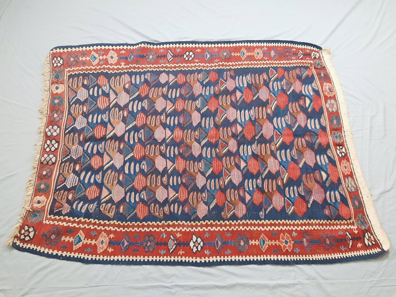 Senneh Kilim Area Rug: Hand woven. All-Over pattern set in a blue field with red and ivory highlights. Circa 1980s. 3'8" wide x 5' long. Some stretching to all sides. LR IMPORTANT: Before bidding, please read the terms and 