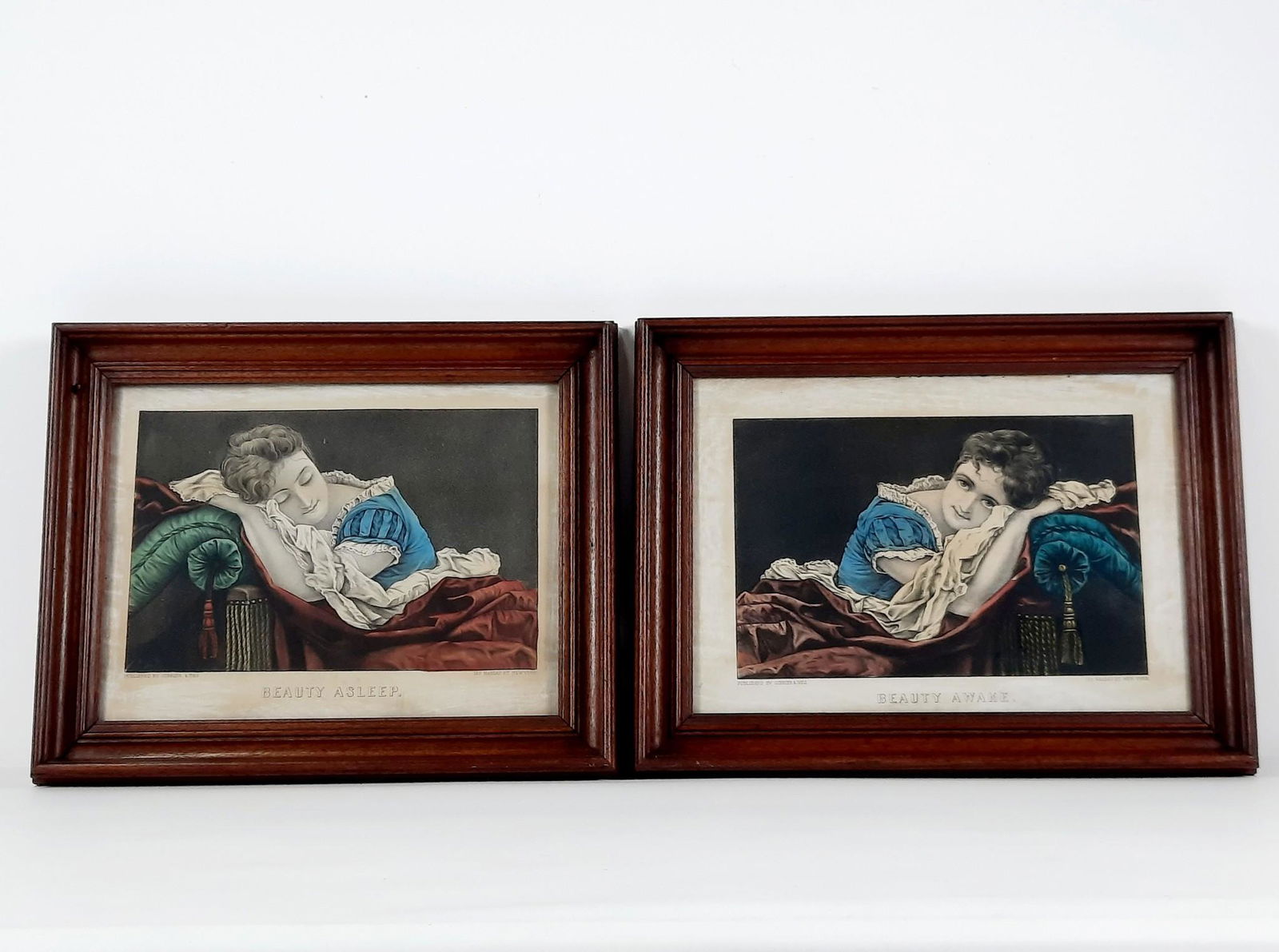 2 Currier and Ives Prints incl Beauty Asleep and Beauty Awake: Each overall with frame 14-1/2" high x 18-1/4" wide. LR IMPORTANT: Before bidding, please read the terms and conditions. When you registered for the auction you agreed to these terms and will be requi