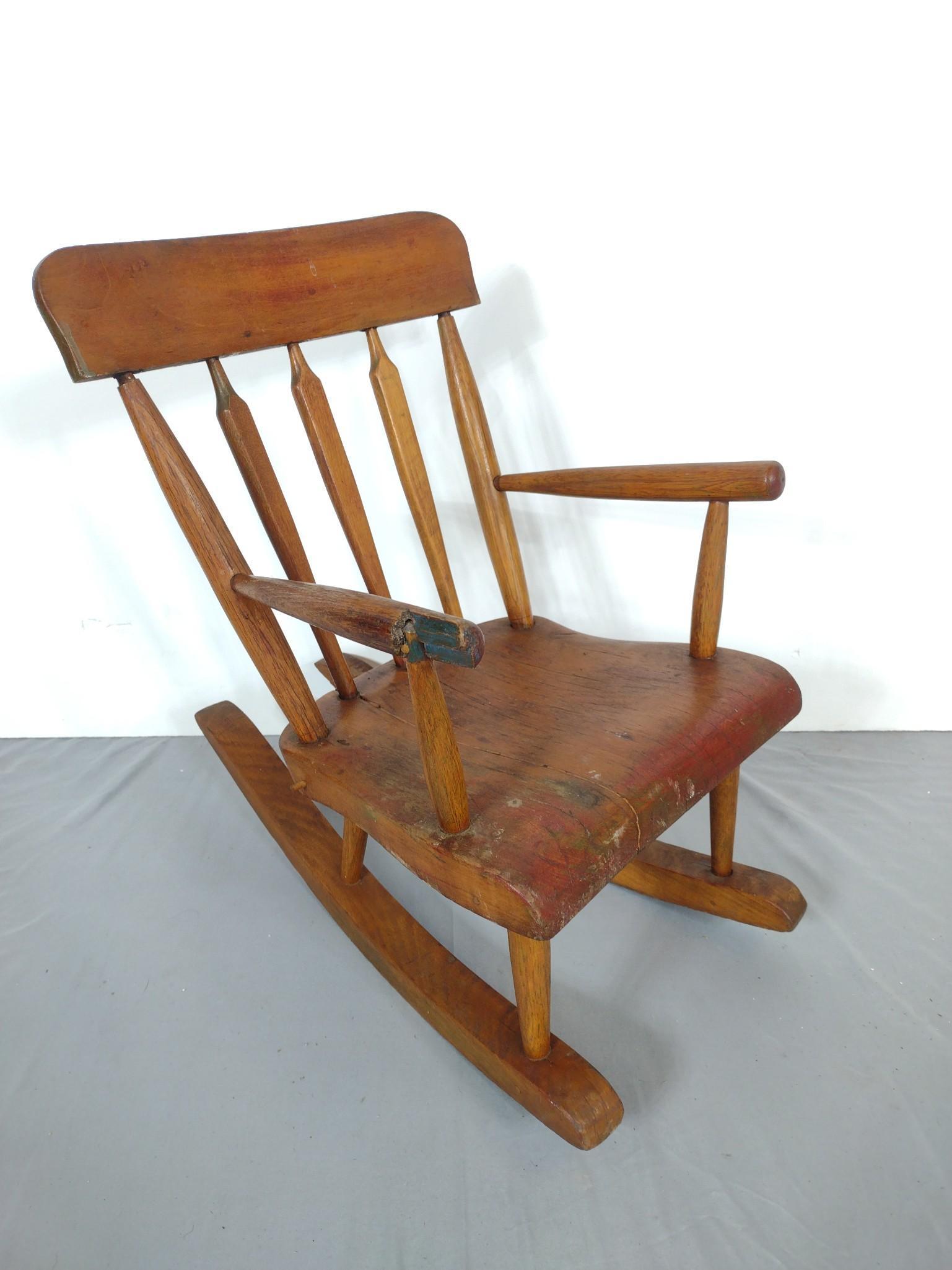 Child's Rocker: 14" wide X 21-1/2" deep X 21" high. Has some discoloring. One arm rest has loss. MG. IMPORTANT: Before bidding, please read the terms and conditions. When you registered for the auction you agreed to 