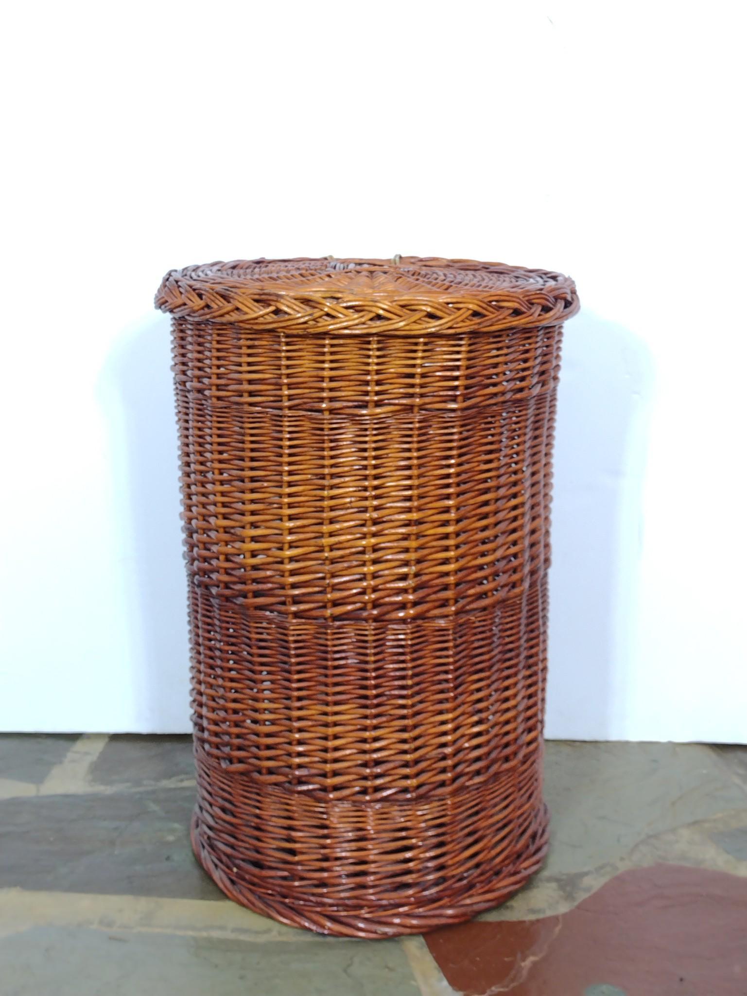 Wicker Hamper: 18" diameter X 27-1/2" high. MG. IMPORTANT: Before bidding, please read the terms and conditions. When you registered for the auction you agreed to these terms and will be required to comply with them