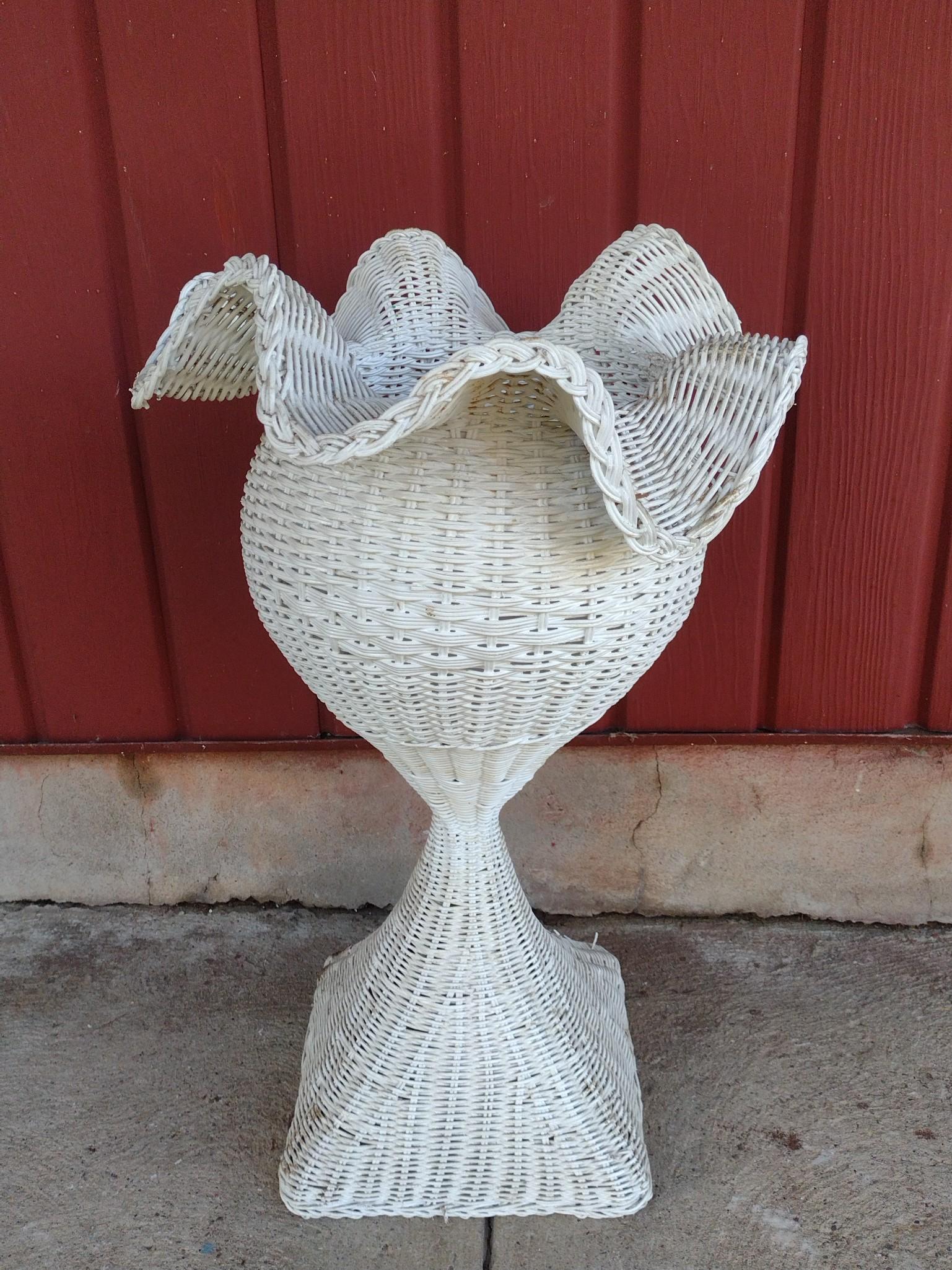 Wicker Planter: 15" diameter X 26" high. Has some discoloring. MG. IMPORTANT: Before bidding, please read the terms and conditions. When you registered for the auction you agreed to these terms and will be required t