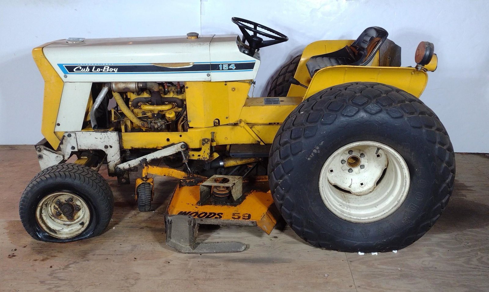 International Cub Lo-Boy 154 With Tiller, Lawn Sweeper & Plow: Serial 2000112U. Cranks but does not start. Needs carburetor rebuilt. Front tires are flat. 62" wide X 96" long X 42" high. Woods 59 deck. 38" Lawn Sweeper 44" wide X 55" deep X 30" high. Internationa