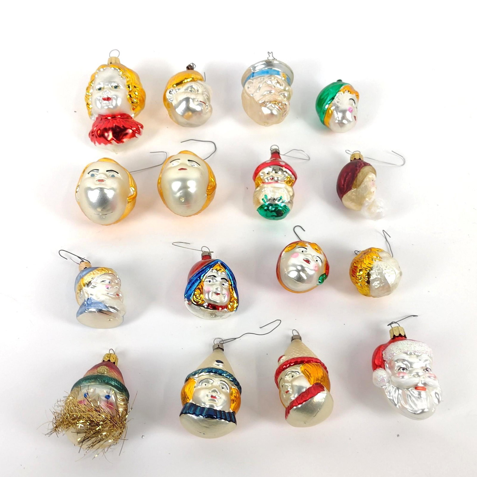 16 Glass Face Ornaments incl Santa: 3" to 4-1/2" high. MEG IMPORTANT: Before bidding, please read the terms and conditions. When you registered for the auction you agreed to these terms and will be required to comply with them.