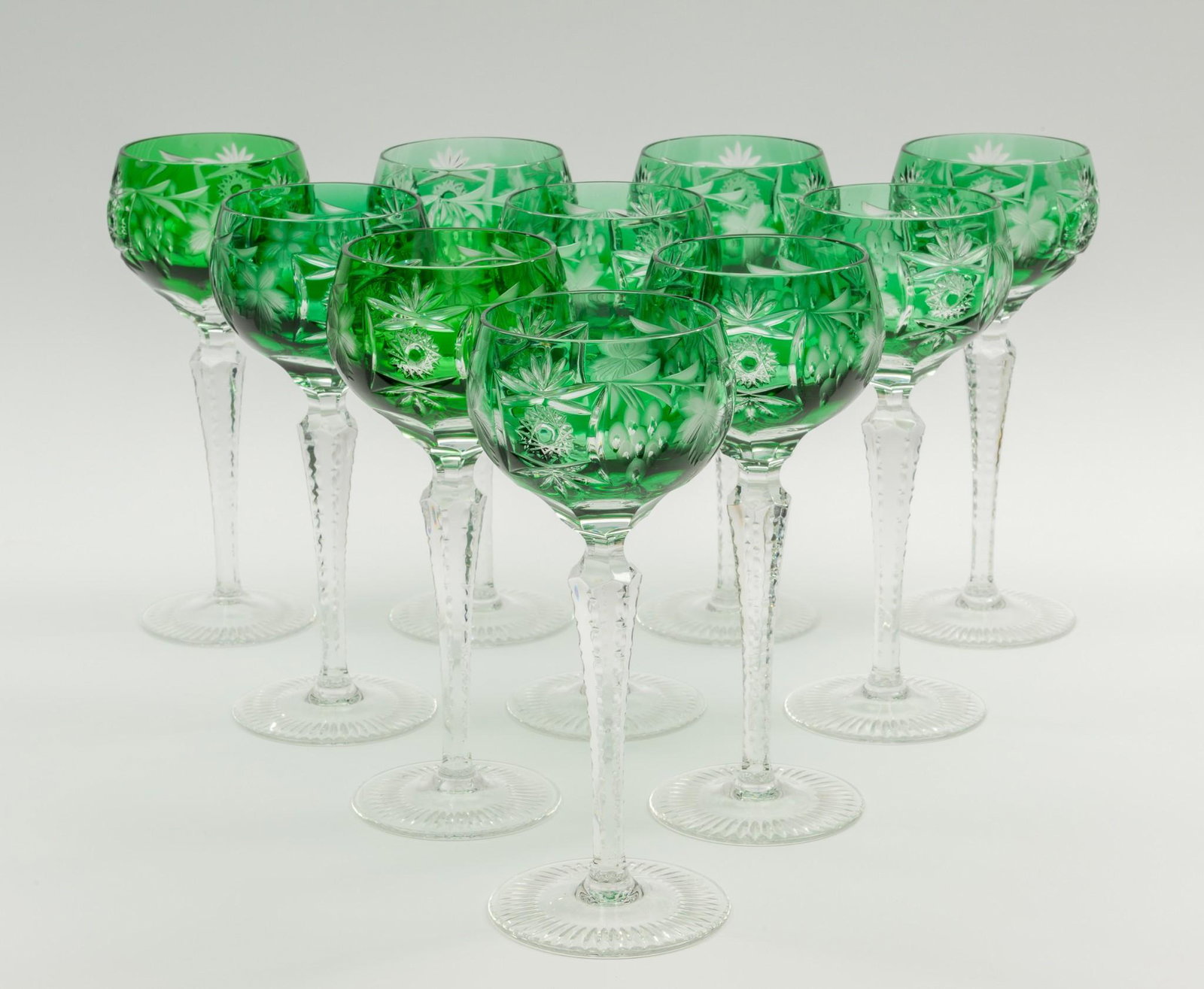 10 Pcs Nachtmann "Traube" Cut Crystal Stemware: DESCRIPTION: Ten pieces Nachtmann cut crystal stemware. In the Traube pattern, 1940. Includes ten emerald green tall hock wine glasses. MEASUREMENTS: 8-1/4" high. CONDITION: No defects noted. DP. IMPO