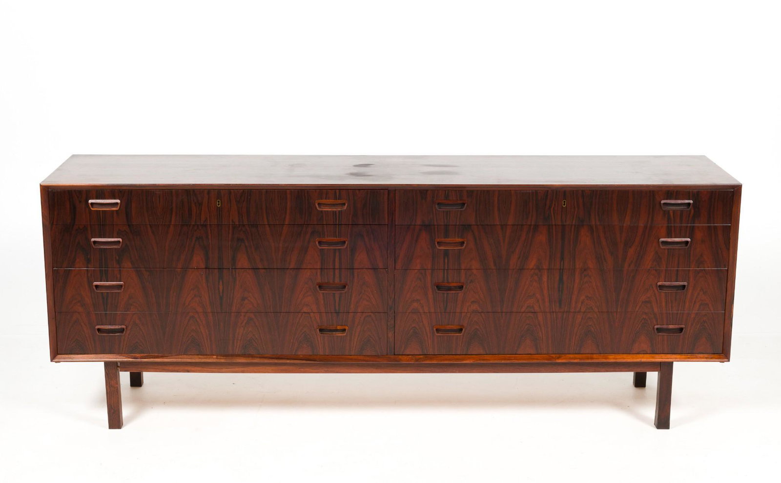Mid Century Modern Danish Rosewood Credenza: DESCRIPTION: Mid century modern Danish rosewood credenza. Eight drawers with recessed handles. Maple interior. Unsigned. MEASUREMENTS: 78" wide x 17-1/2" deep x 29" high. CONDITION: Very good. Minor l