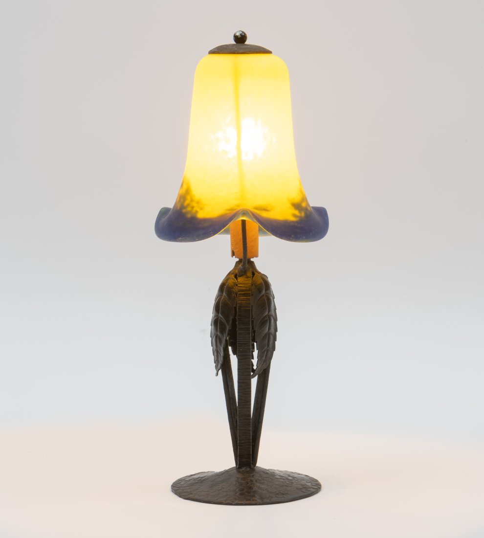 Antique Lamp with Hand Wrought Base and Art Glass Shade: DESCRIPTION: Antique lamp with hand wrought bronze base and blue and yellow art glass vase. MEASUREMENTS: Shade 5" diameter at widest point, 12-1/2" high overall. CONDITION: Works. Crack to chase. Rep