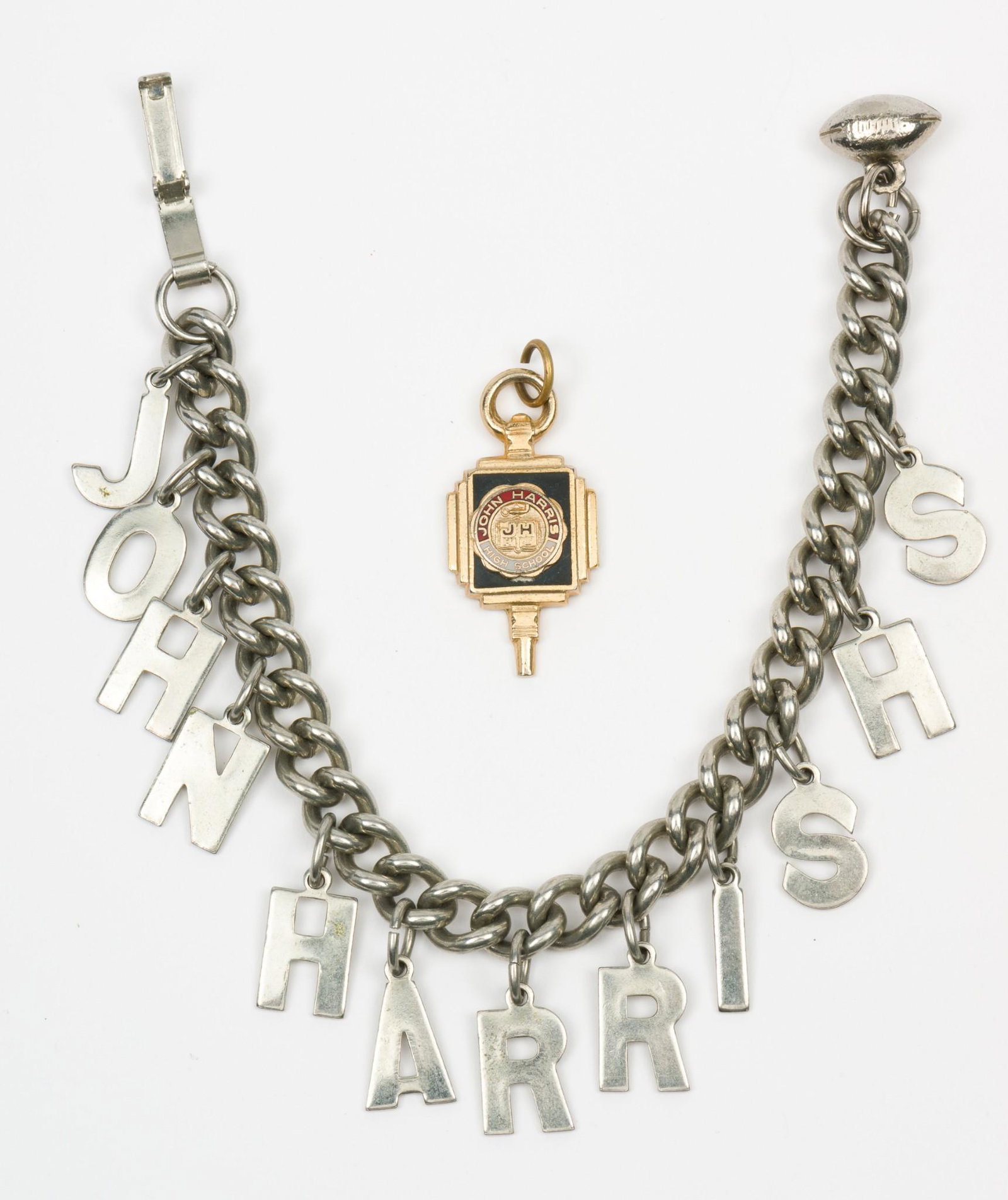 John Harris High, Harrisburg Charm Bracelet and Pendant: Bracelet with football charm circa 1954-1955 6-1/2" long with 3/4" long charms. John Harris pendant circa 1955 1-1/4" long. MH. IMPORTANT: Before bidding, please read the terms and conditions. When yo
