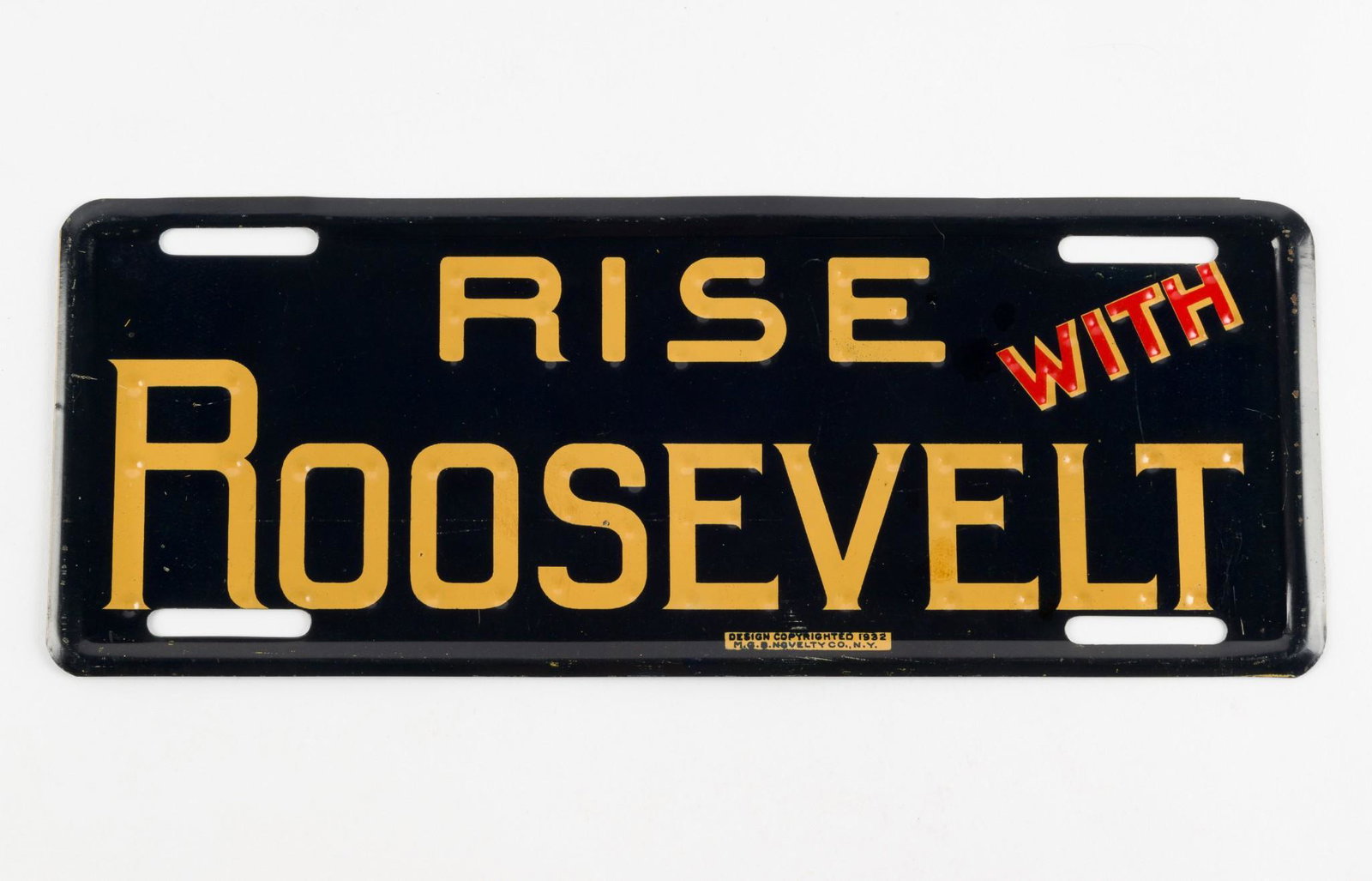 Rise With Roosevelt License Plate Topper: Design copyrighted 1932 by M.G.B. Novelty Co., N.Y.11-3/4" long x 4-1/2" wide. Some overall wear. RM IMPORTANT: Before bidding, please read the terms and conditions. When you registered for the auctio
