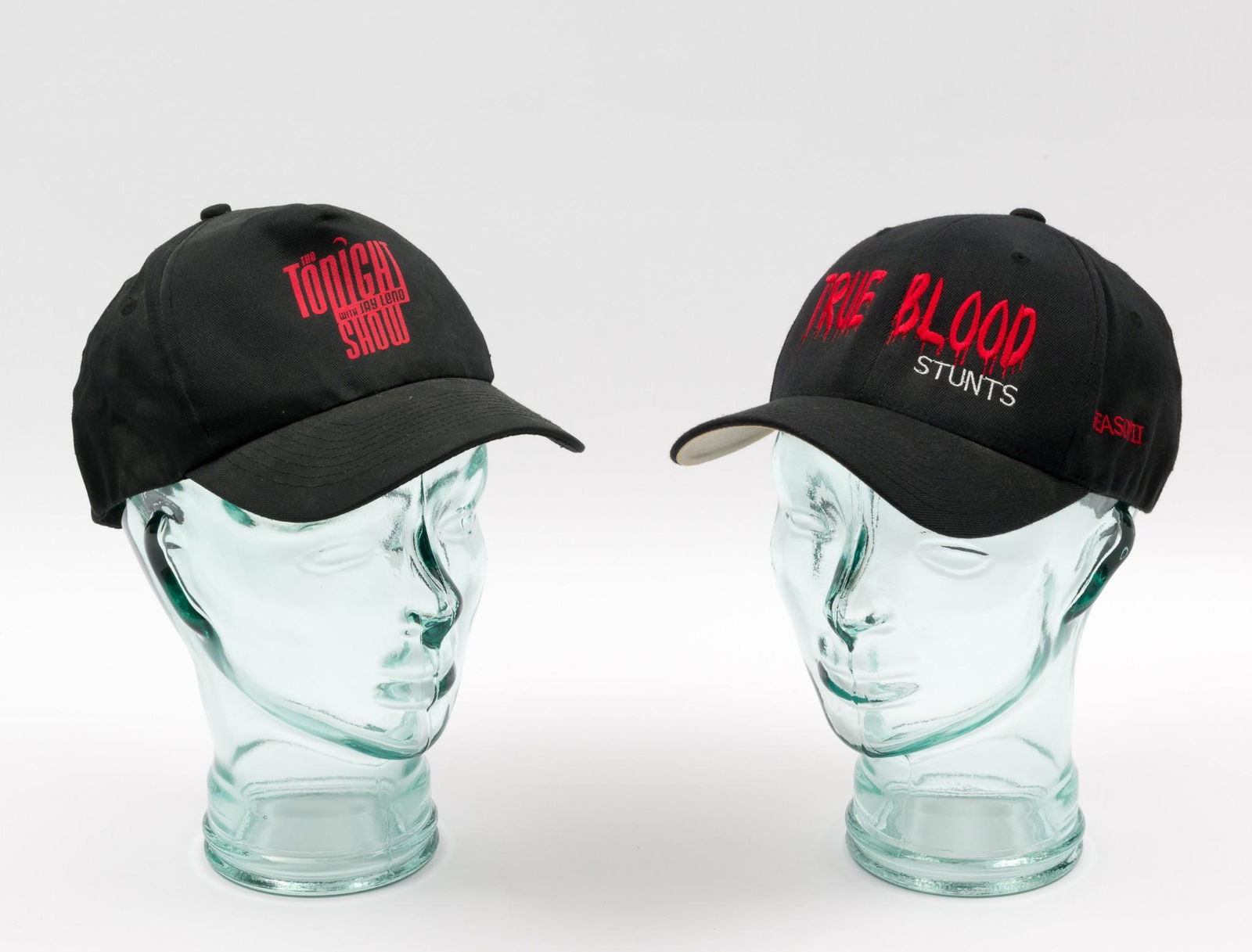 Tonight Show and True Blood Ball Caps: Baseball caps from The Tonight Show with Jay Leno and True Blood, Stunts, Season II. Owned by actor William Sanderson. Leno hat one size fits all and True Blood hat size L-XL. PROVENANCE: From the col