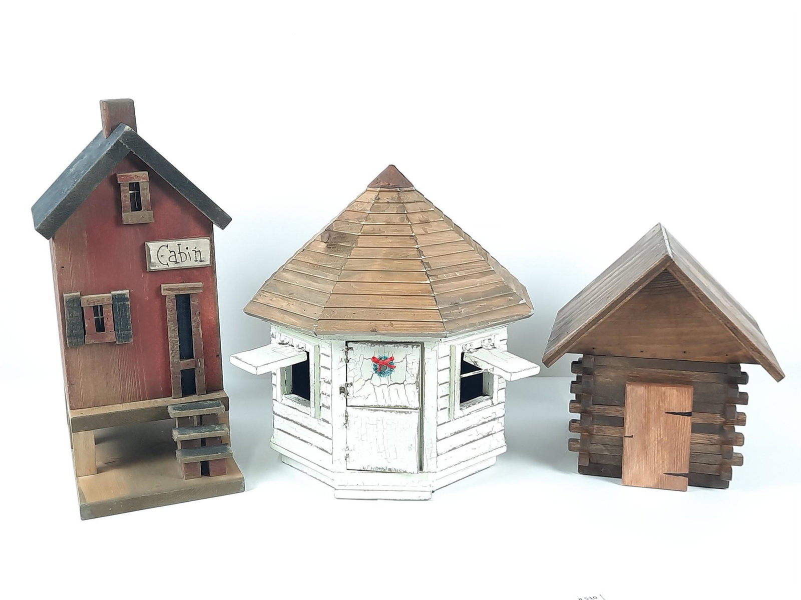 3 Wooden Village Buildings incl Cabin: Red cabin signed "PW 2005". Also includes octagonal hut and log cabin. 8-1/2" to 13-1/2" wide x 11-1/2" x 18" high. LR IMPORTANT: Before bidding, please read the terms and conditions. When you registe
