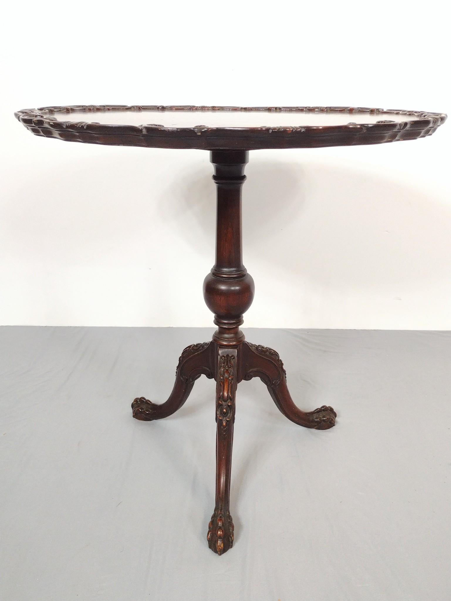 Carved Pie Crust Table: 29" diameter X 29-1/2" high. Has a few scratches. MG. IMPORTANT: Before bidding, please read the terms and conditions. When you registered for the auction you agreed to these terms and will be require