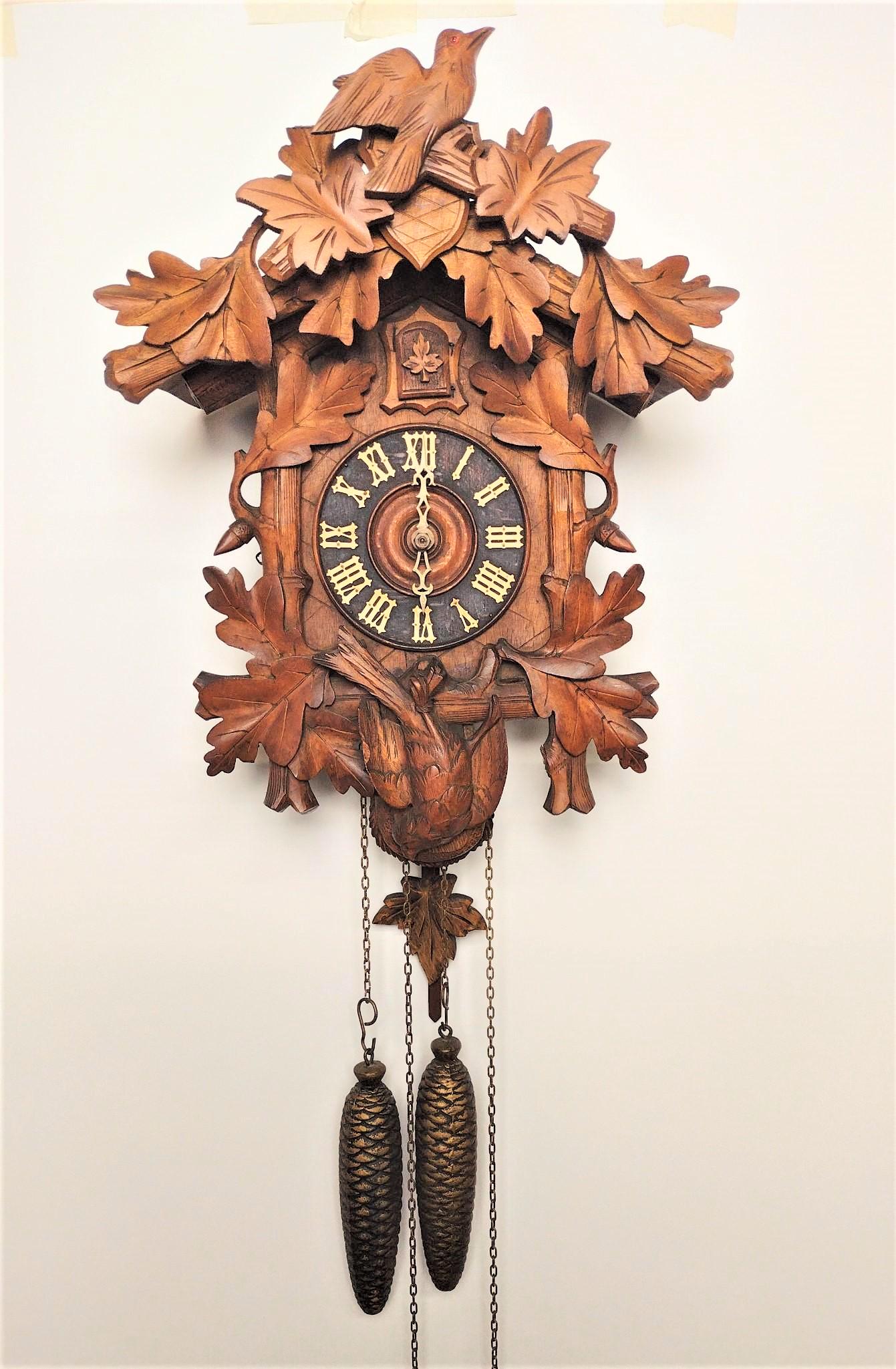 Intricately Carved Cuckoo Clock: Working. 11" wide x 6-3/3" deep x 17" high. Bottom bird loose. RM IMPORTANT: Before bidding, please read the terms and conditions. When you registered for the auction you agreed to these terms and wil