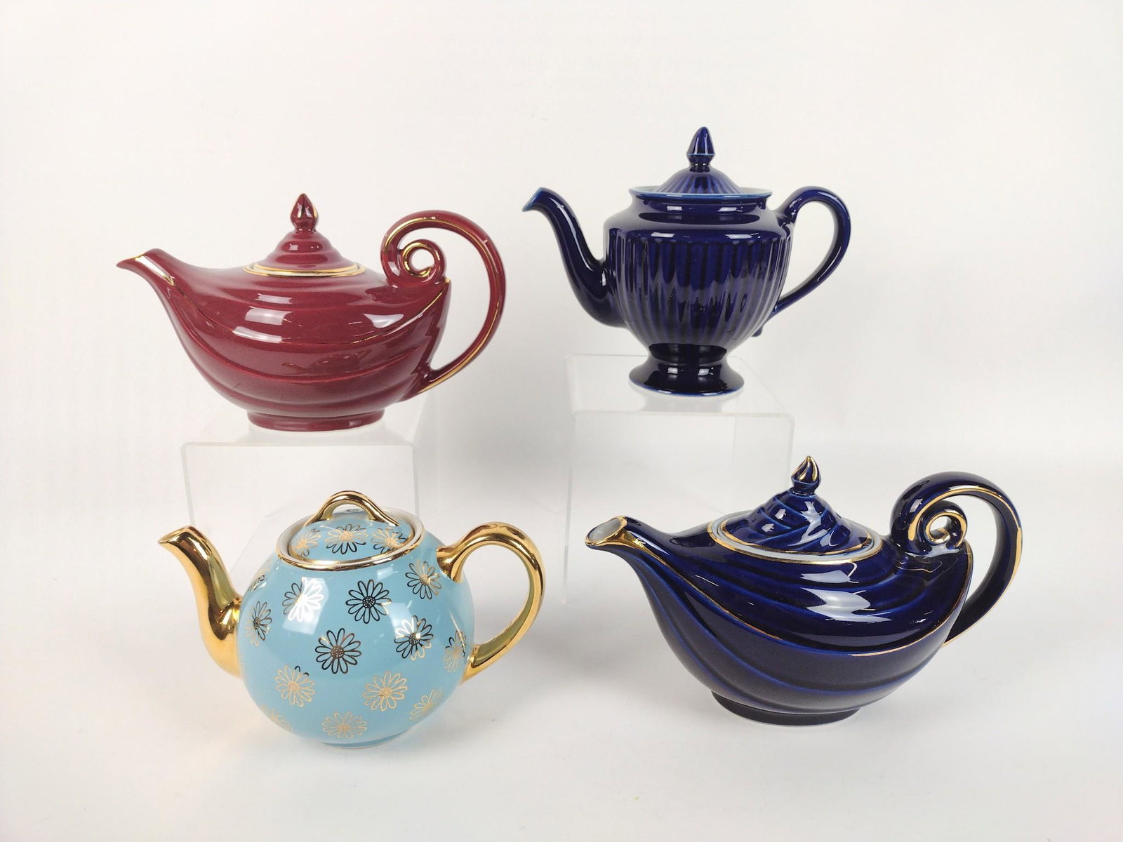 4 Hall Tea Pots: 6" - 7-3/4" high. RM IMPORTANT: Before bidding, please read the terms and conditions. When you registered for the auction you agreed to these terms and will be required to comply with them.