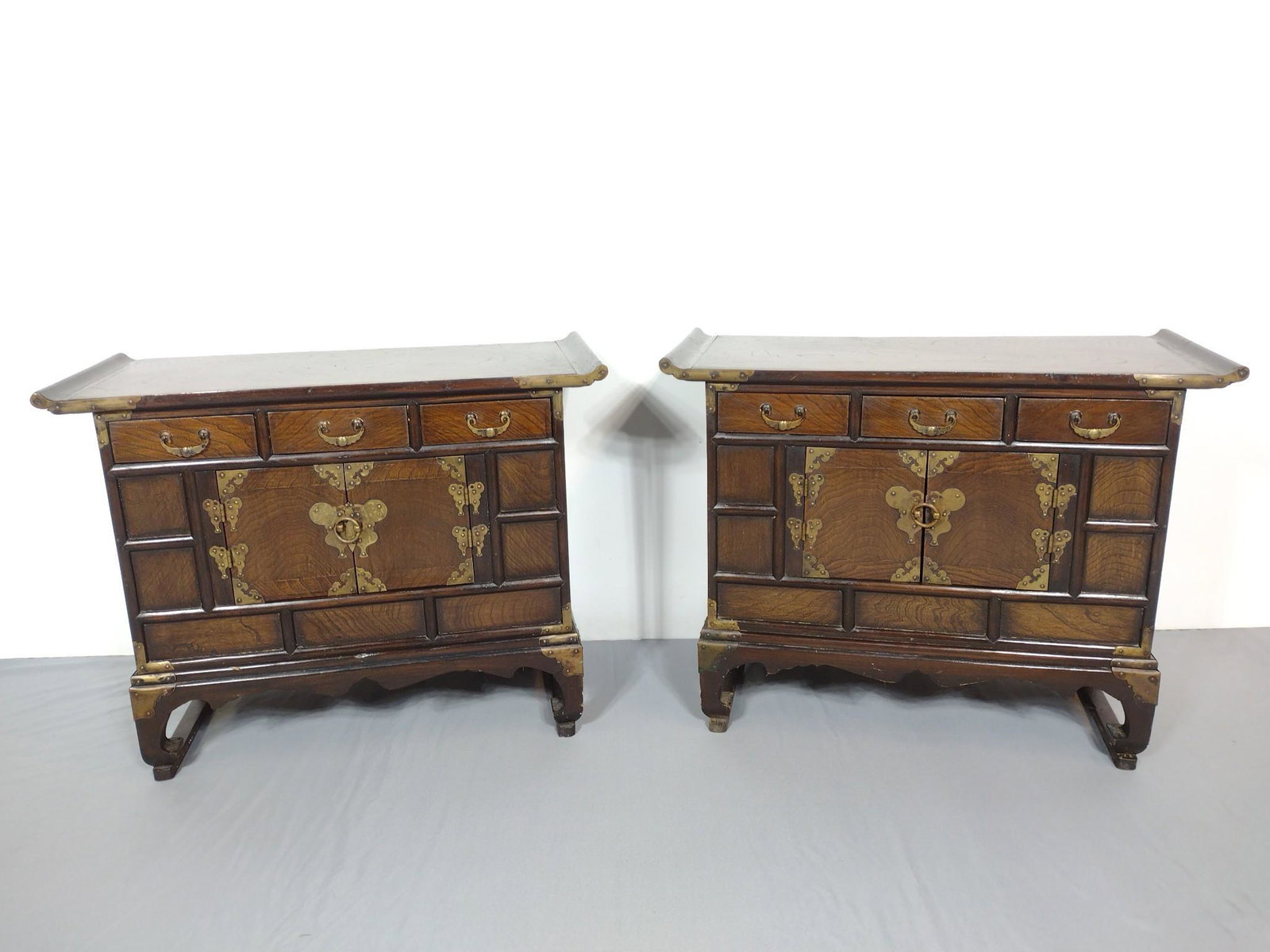 Pair Of Low Asian Cabinets: 27" wide X 12" deep X 21" high. Both have some light scratches. MG. IMPORTANT: Before bidding, please read the terms and conditions. When you registered for the auction you agreed to these terms and w