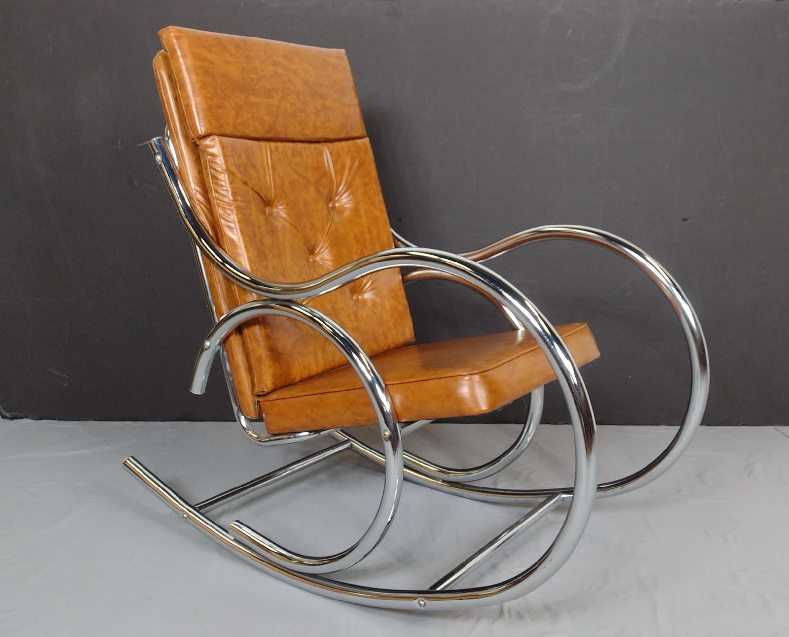 U.S. Furniture Industries Chrome Frame Rocker: 22" wide X 42" deep X 40" high. MG. IMPORTANT: Before bidding, please read the terms and conditions. When you registered for the auction you agreed to these terms and will be required to comply with t