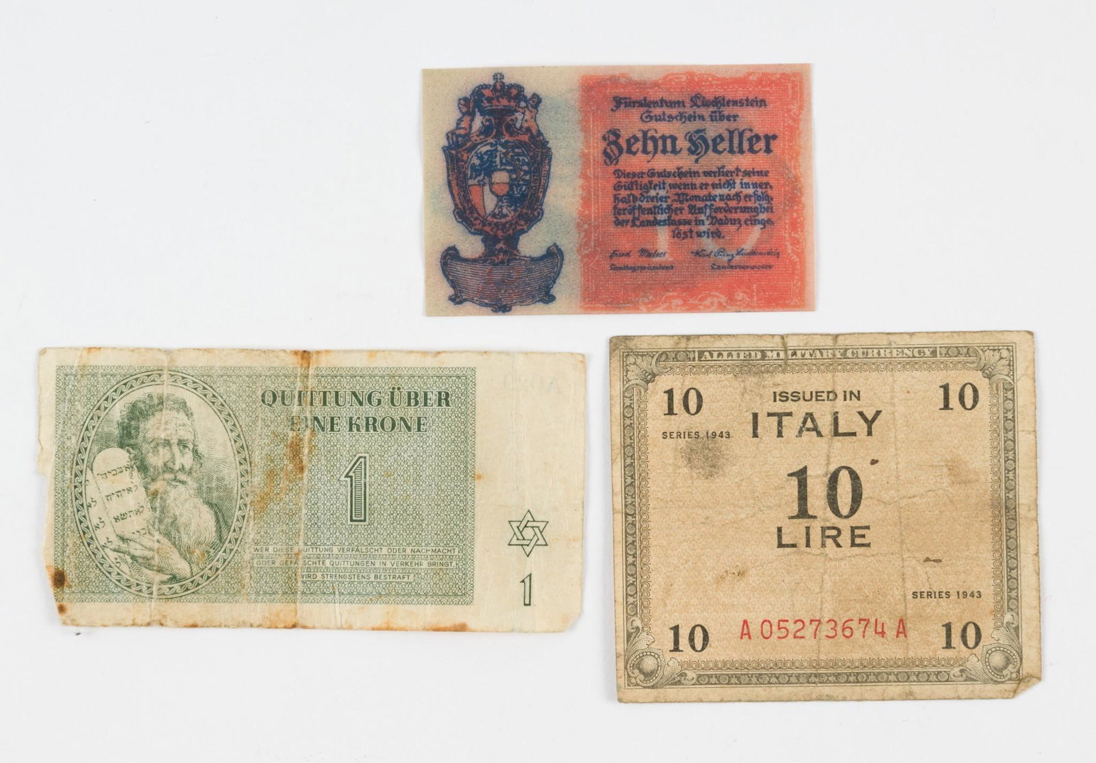 3 Pcs European WWII Currency Incl Concentration Camp: Includes 10 Lire Issued in Italy, dated 1943, 10 Liechtenstein Heller which was part of an emergency printing of money, and one krone, issued in the Theresienstadt (Terezin) ghetto-labor camp in 1943.