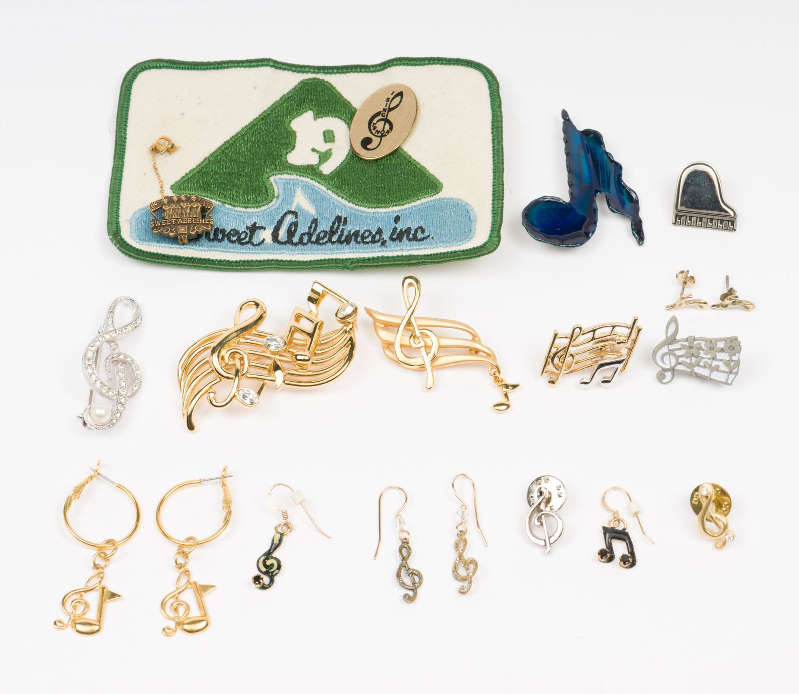Small Grouping Musical Themed Jewelry: Includes pins, earrings, and Sweet Adeline's patch. Pins 1/2" to 2-1/2". Patch 3" x 4-1/2". EK IMPORTANT: Before bidding, please read the terms and conditions. When you registered for the auction you 