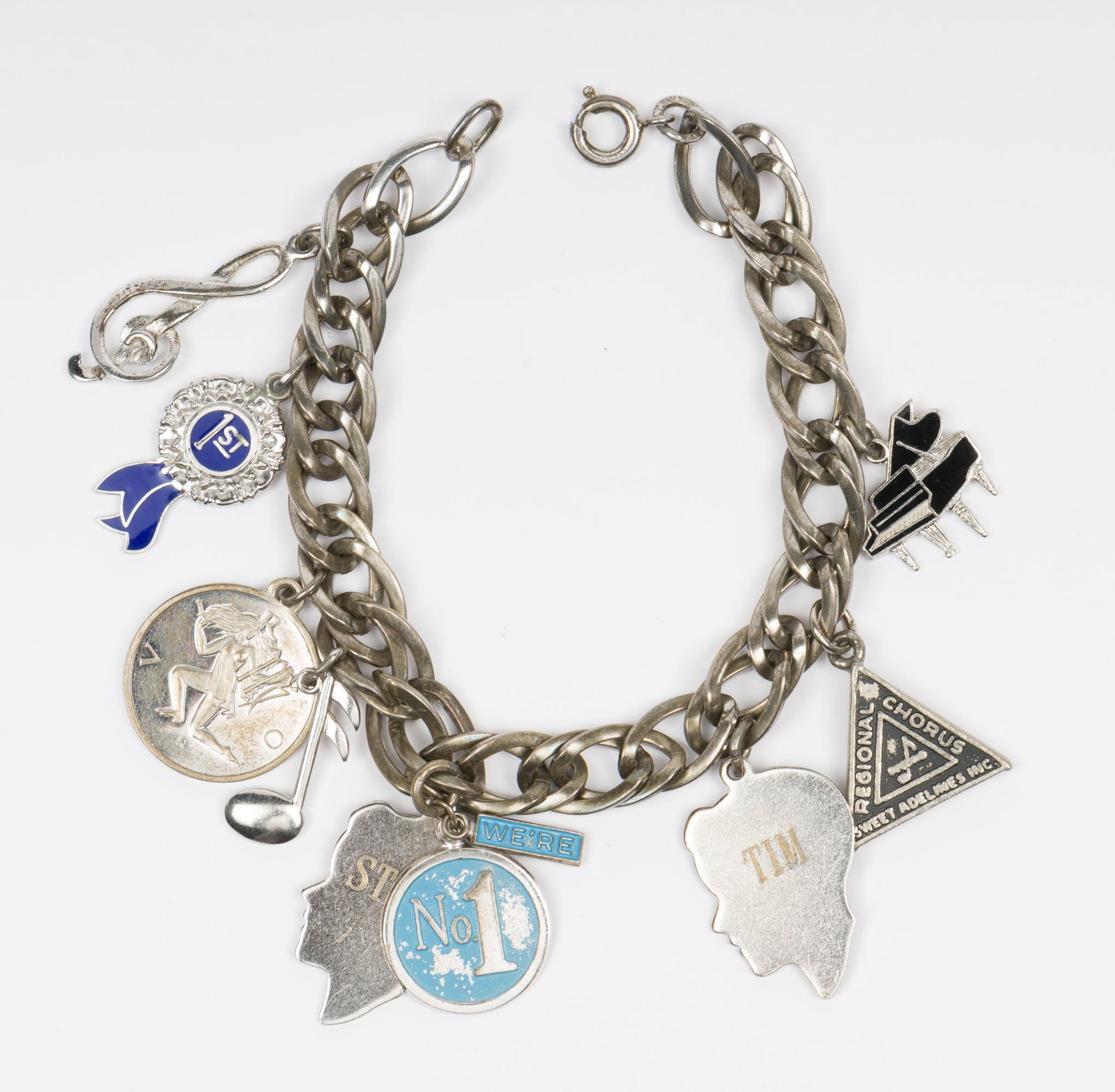 Sterling Charm Bracelet with 9 Sterling Charms: 6-1/2" long. EK IMPORTANT: Before bidding, please read the terms and conditions. When you registered for the auction you agreed to these terms and will be required to comply with them.