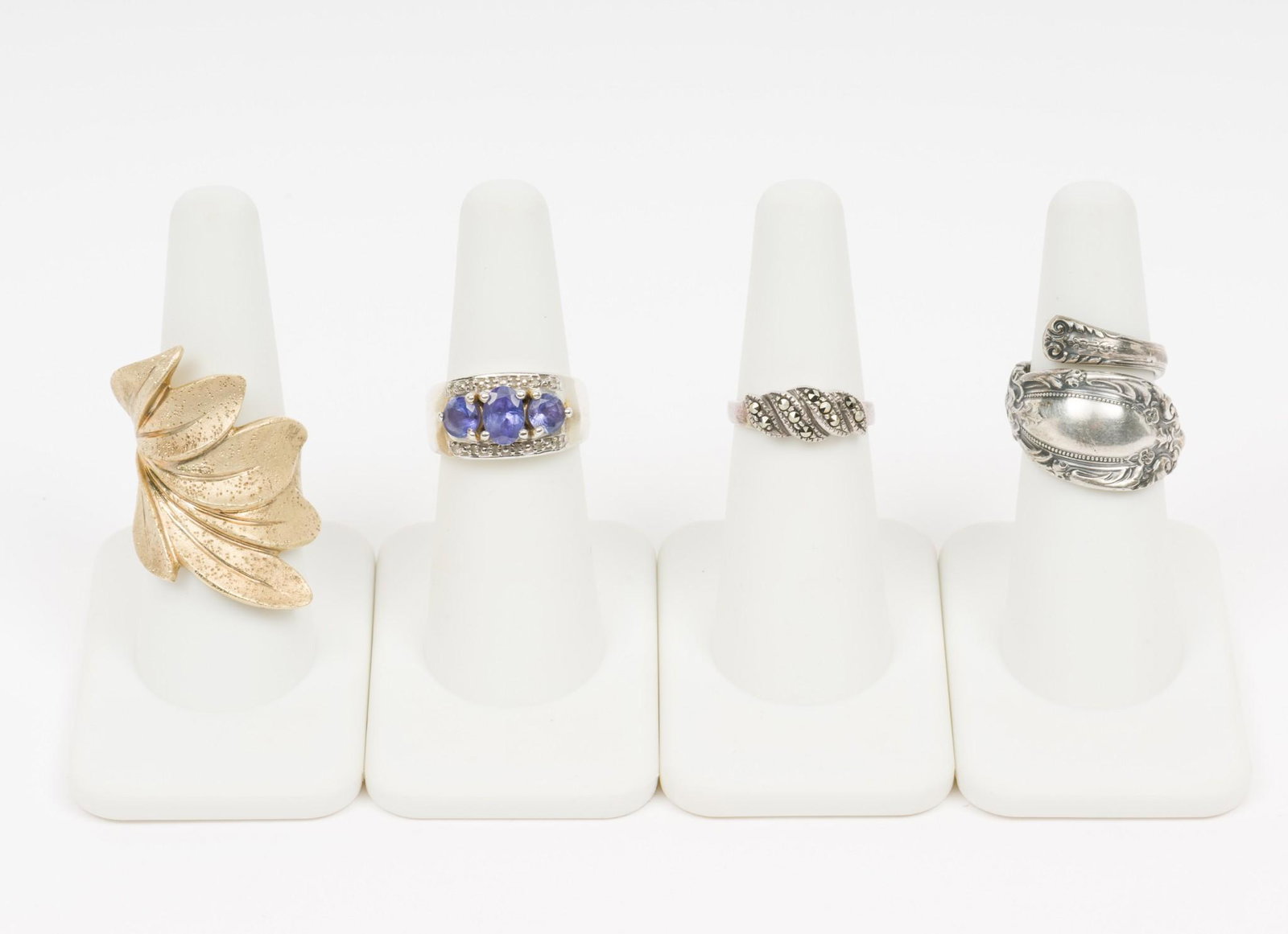 4 Sterling Rings: Includes gold wash, marcasite, and tanzanite with CZ. Sizes 5 to 8. EK IMPORTANT: Before bidding, please read the terms and conditions. When you registered for the auction you agreed to these terms an