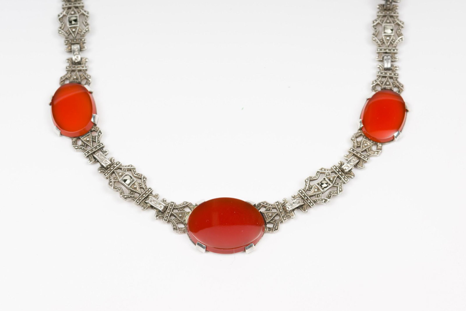 Vintage Sterling Marcasite and Carnelian Necklace: Sterling with marcasites. 7 carnelian sections. 15" length. 1/8" width at largest carnelian disc. IMPORTANT: Before bidding, please read the terms and conditions. When you registered for the auction y