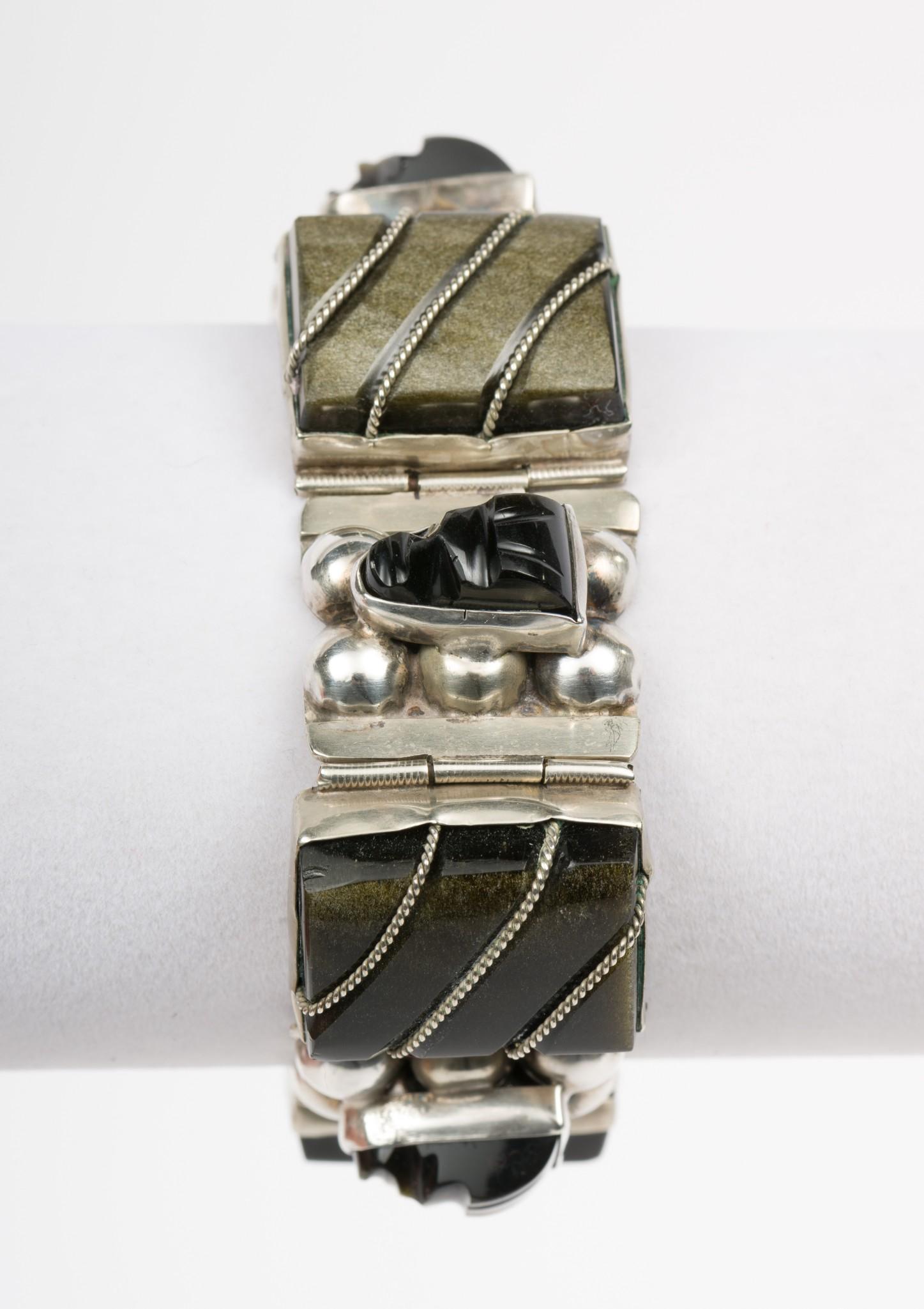 Mexican Silver, Onyx & Obsidian Bracelet: 7" length x 1" width. Marked sterling Mexico in circle. One onyx with loose twisted silver wire detached. IMPORTANT: Before bidding, please read the terms and conditions. When you registered for the a