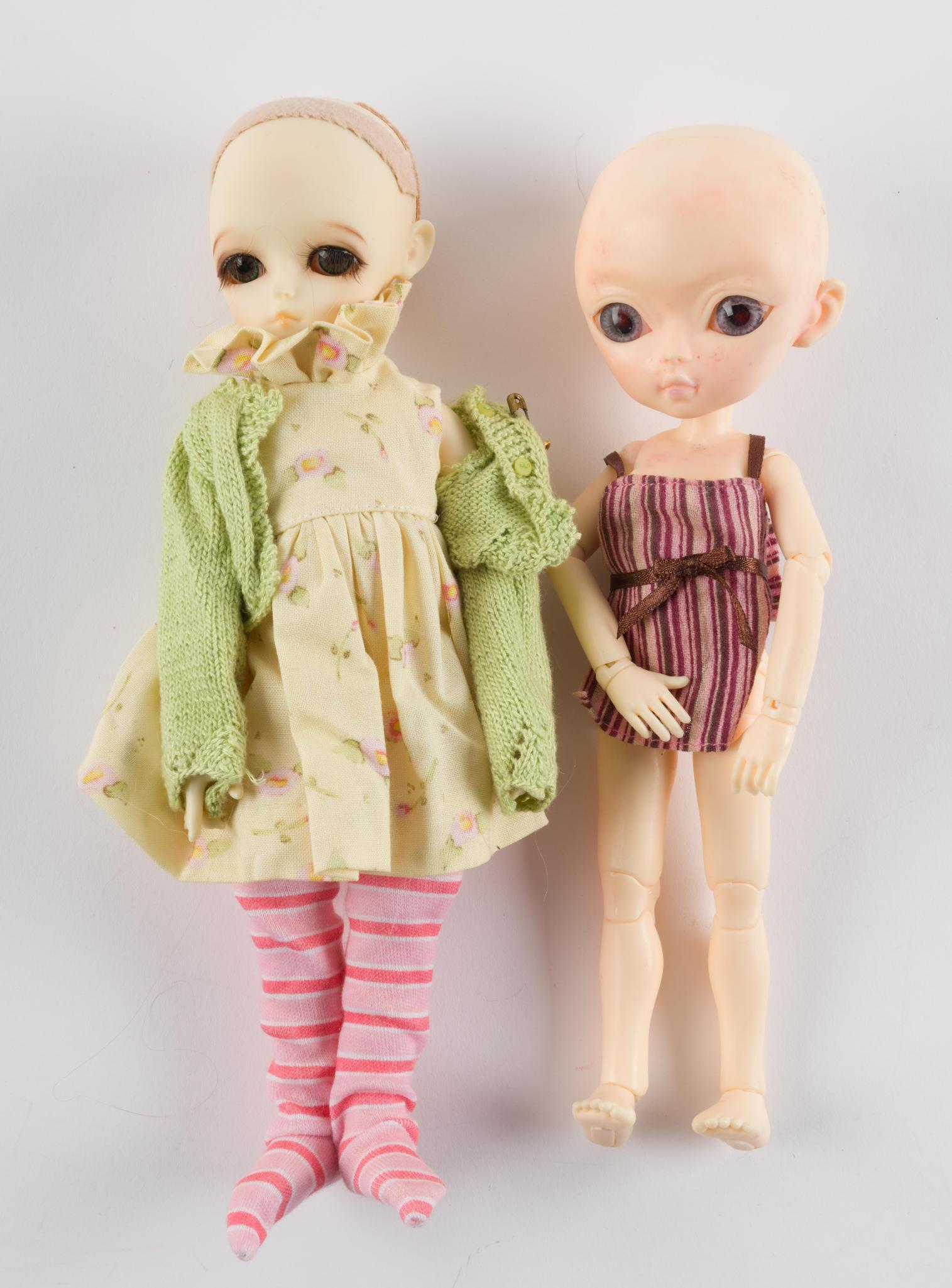 2 Hujoo Dolls: One face up. Other with scratch to left eye. 9" and 10". LR IMPORTANT: Before bidding, please read the terms and conditions. When you registered for the auction you agreed to these terms and will be r