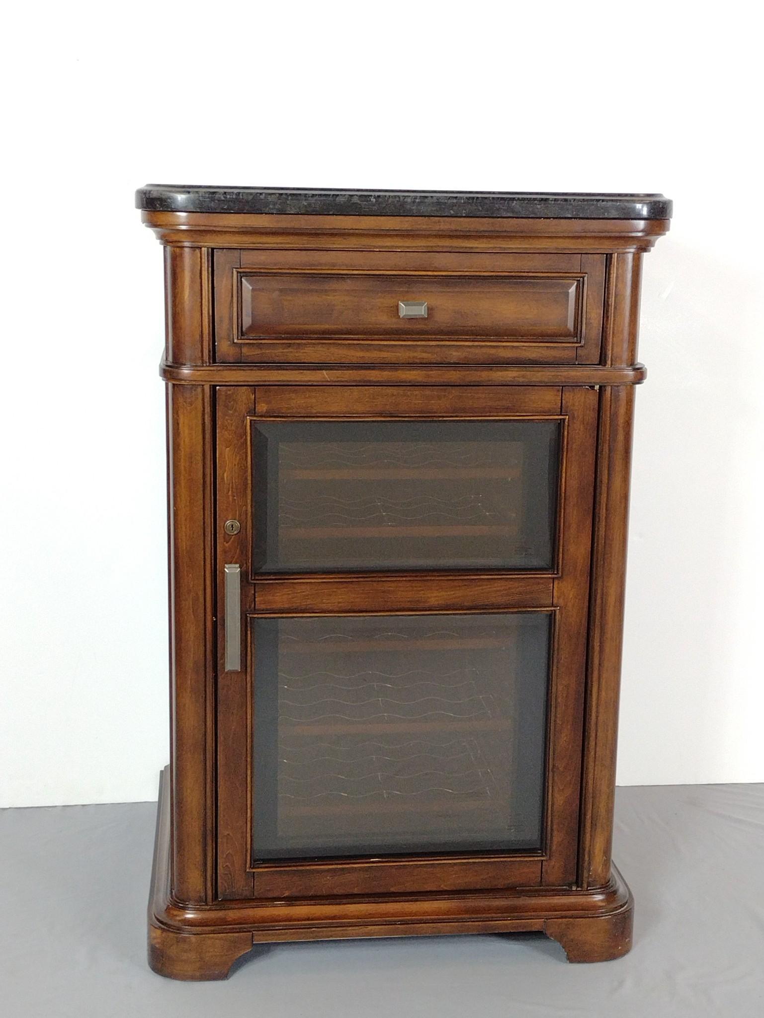 Twin-Star International Wine Cooler: Working. 29" wide X 24-1/4" deep X 44-1/2" high. Has some finish loss on right side foot board. MG. IMPORTANT: Before bidding, please read the terms and conditions. When you registered for the auction