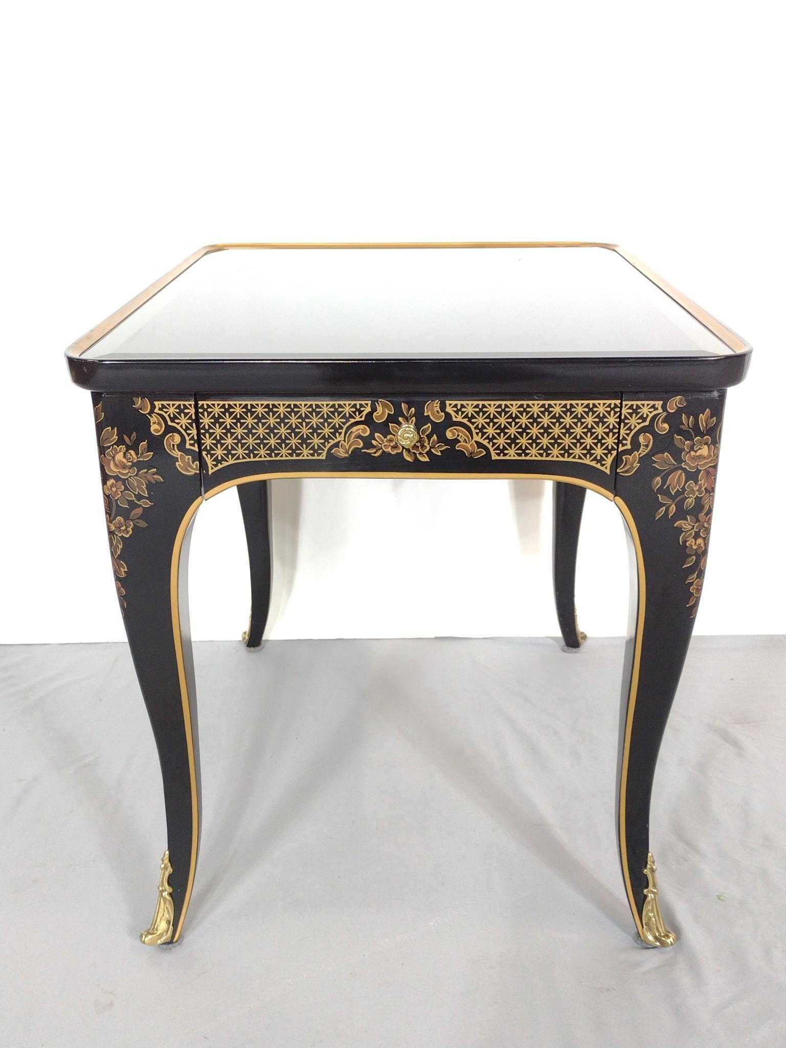 Drexel Chinoiserie Table With Black Glass Top: 21" wide X 26" deep X 22-1/2" high. MG. IMPORTANT: Before bidding, please read the terms and conditions. When you registered for the auction you agreed to these terms and will be required to comply wi