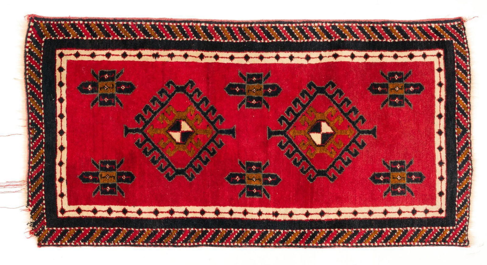 Vintage Turkish Runner: Tribal medallions set in a red field with black and white highlights. 4' 4" long x 2' 3" wide. Circa 1970s. IMPORTANT: Before bidding, please read the terms and conditions. When you registered for the