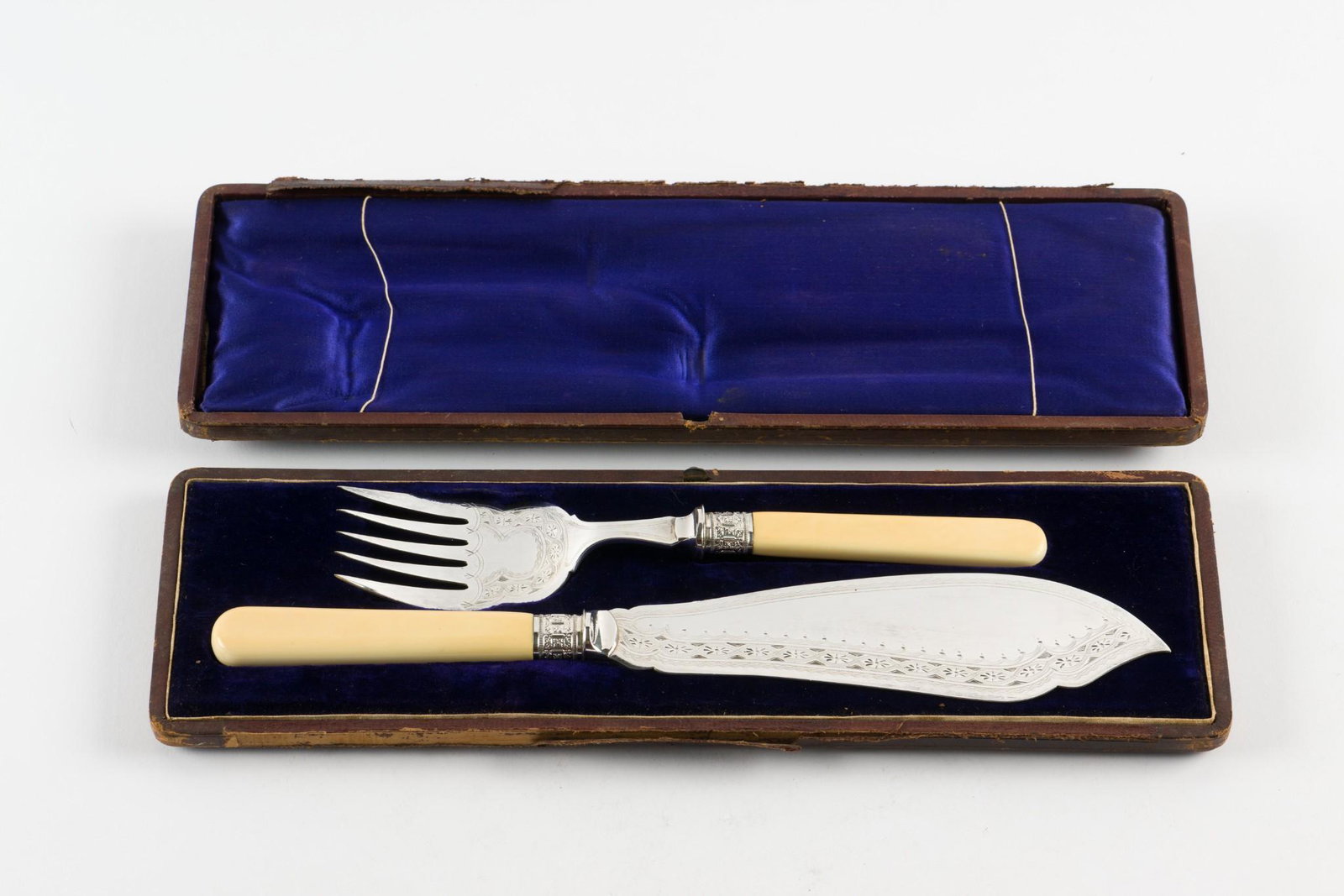 Vintage Silver Plated Fish Knife and Fork Set: Fish knife and fork with bone handles. In original velvet and satin lined case. Not marked. Fork 9-3/8" long. Knife 12-1/2" long. Light surface scratches as expected with careful use. Cracks to back o