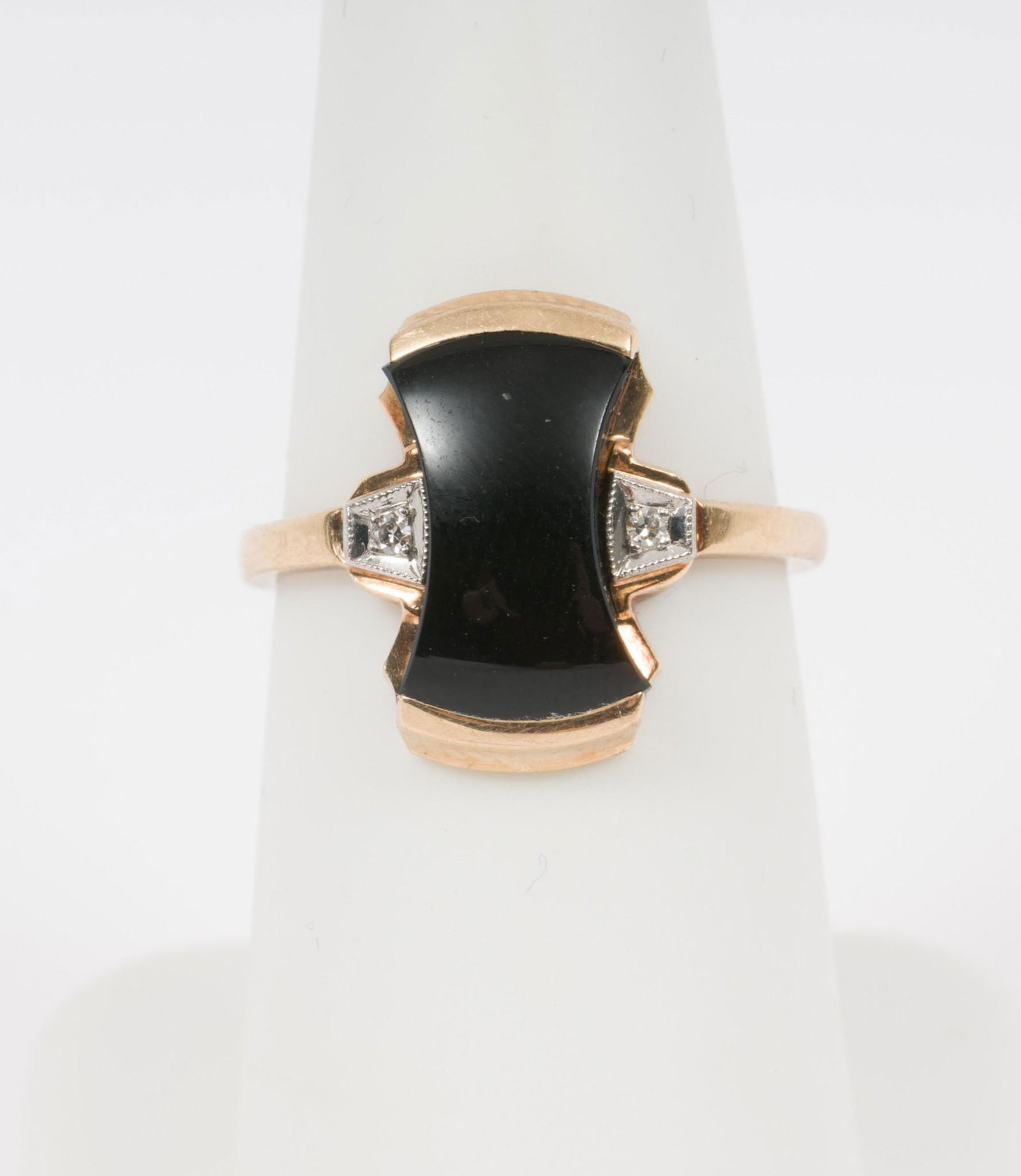 10k Onyx And Diamond Ring: Two .01 carat each round single cut diamonds. Size 6. 1/2" wide. 1.8 dwt. AJ/MH/EK. IMPORTANT: Before bidding, please read the terms and conditions. When you registered for the auction you agreed
