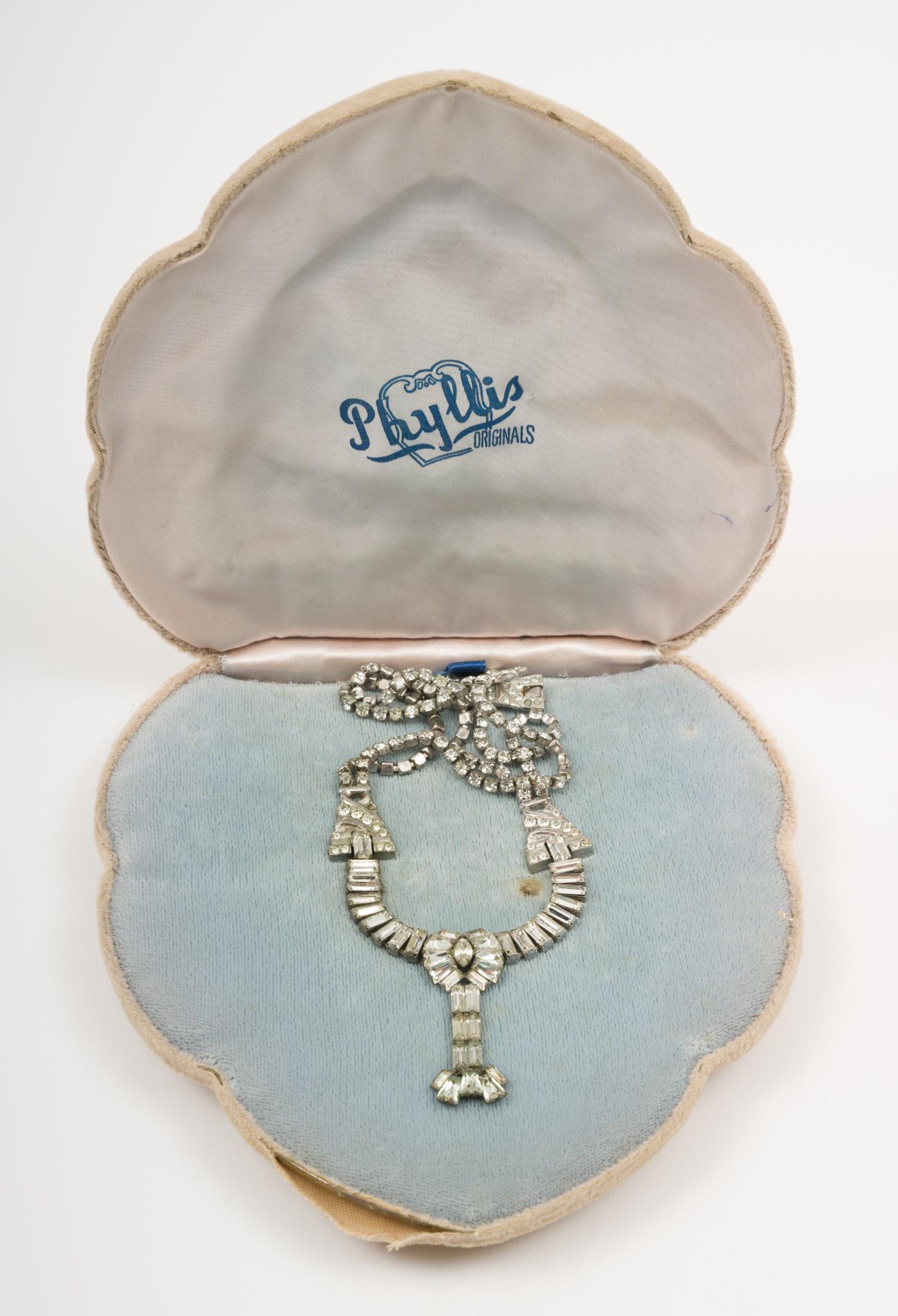 Vintage Phyllis Originals Sterling And Rhinestone Necklace In OB: Marked sterling Phyllis. In original gift box. 14" long with 2" tassel. Wear to box. AJ/MH IMPORTANT: Before bidding, please read the terms and conditions. When you registered for the auction you agre