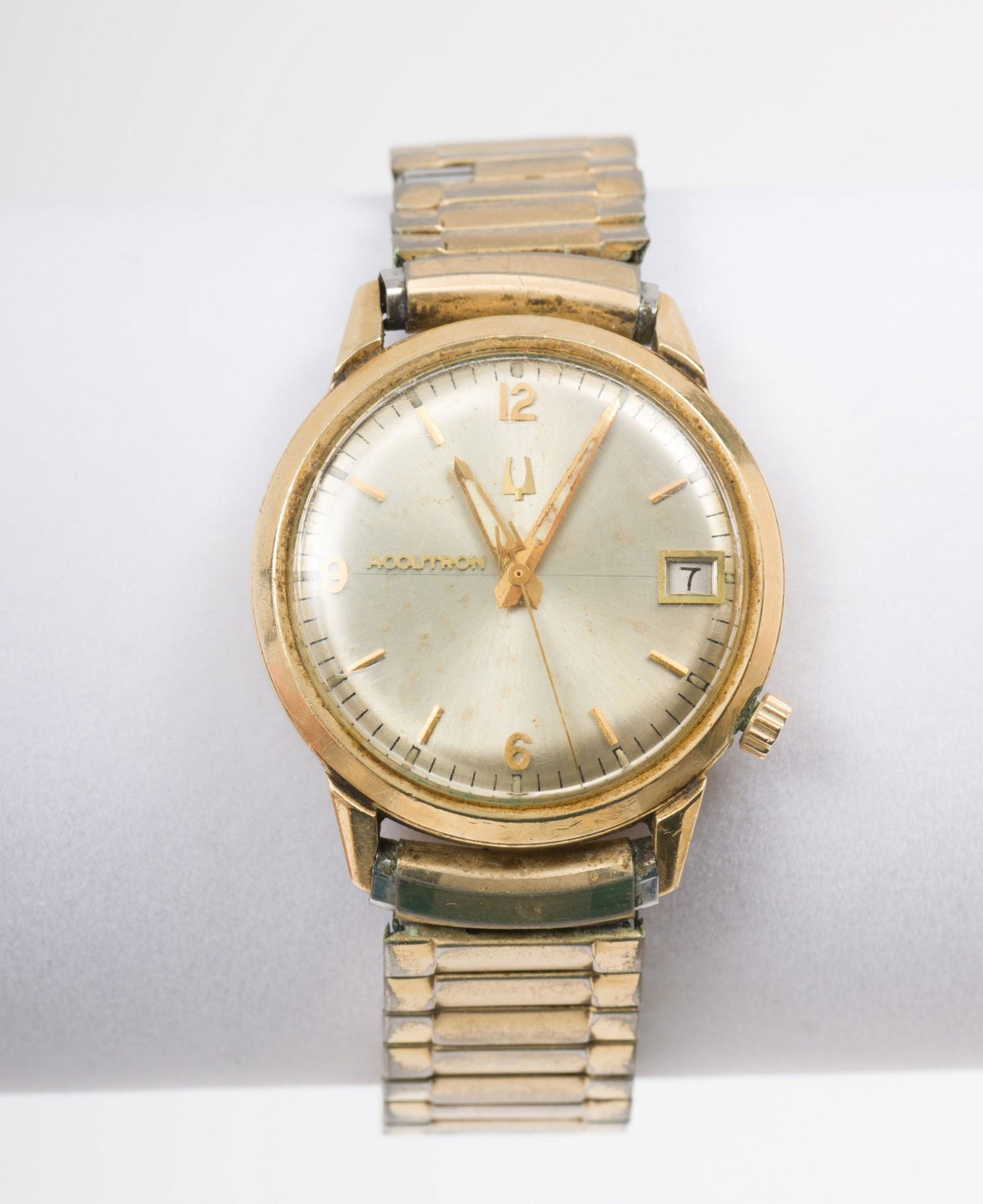 Vintage Men's Accutron by Bulova Wristwatch in OB: Accutron by Bulova men's wristwatch. Gold-filled case. Elastic band. In original box with paperwork. 1-5/8" lug to lug. Not tested. Wear to band. DP. IMPORTANT: Before bidding, please read the te