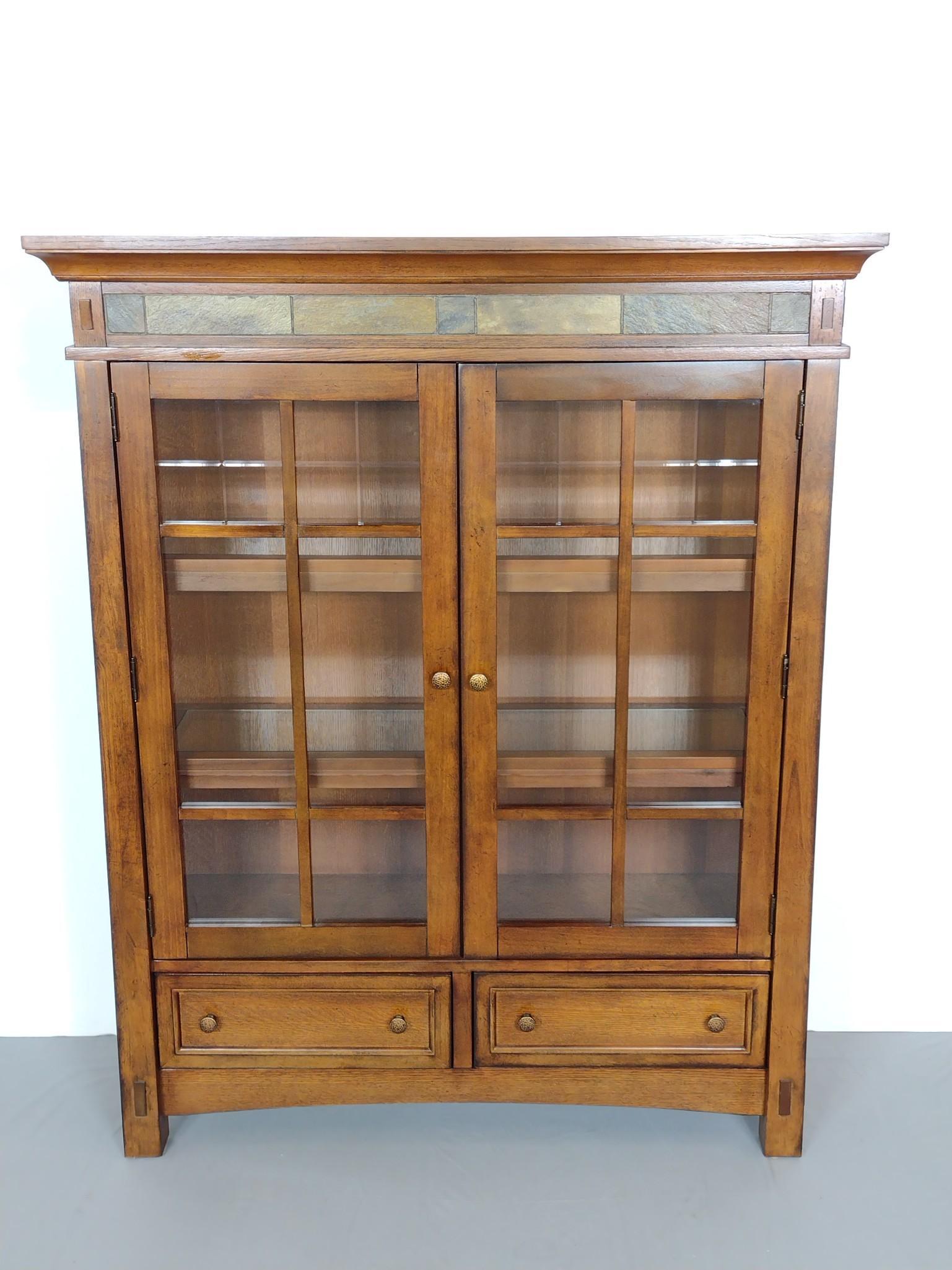 Riverside Furniture Glass Door Bookcase With Lights: Faux hardstone boarder at top. 48" wide X 15" deep X 60-1/4" high. Light is working. MG. IMPORTANT: Before bidding, please read the terms and conditions. When you registered for the auction you agreed